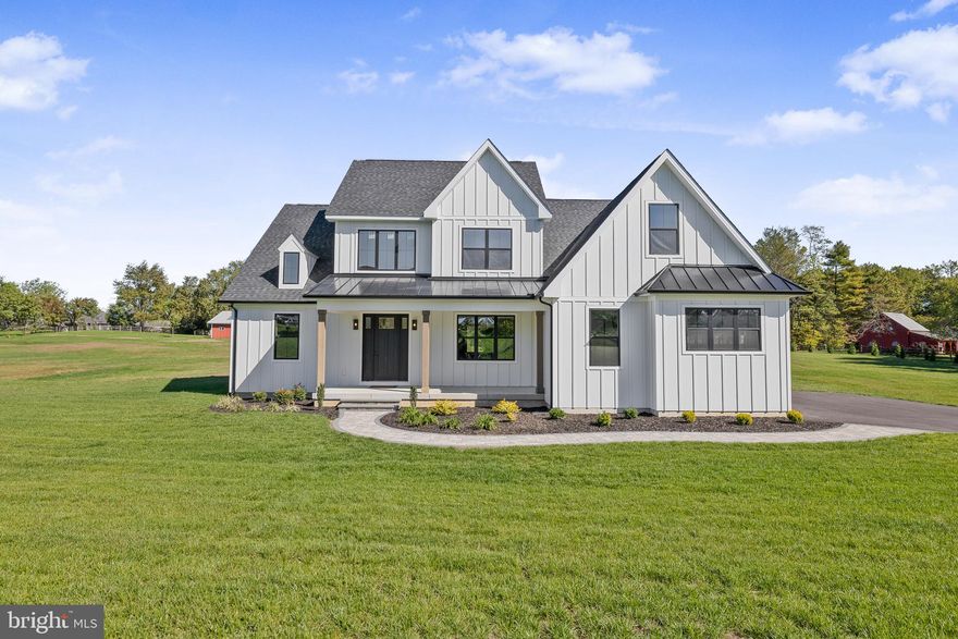 Modern Luxury Meets Timeless Craftsmanship on a Private 1-Acre Estate
Welcome to this stunning custom-built luxury residence, meticulously designed to combine
modern elegance, high-end finishes, and thoughtful functionality. Situated on a perfectly flat 1-
acre lot, this exceptional home offers over 3,000 square feet of living space, every detail curated
for comfort and sophistication.
The exterior features bold black windows, James Hardie board & batten siding, premium vinyl
siding, and metal roofing and architectural shingles. Car enthusiasts and hobbyists will
appreciate the 800 square feet of garage space, including a 2-car turned garage and a separate 1-
car front-facing garage, both featuring high ceilings and recessed lighting—perfect for storage, a
workshop, or a car lift setup. The oversized, concrete front porch has beautiful rough-cut cedar posts, while a beautifully designed hardscape walkway guides you to the entrance featuring an 8-foot craftsman front door.
Once inside you’ll notice the architecturally pleasing open floor plan, the 9-foot ceilings, the
wide-board white oak hardwood flooring that flows throughout the main level, and the white oak
railings with sleek black horizontal metal balusters that adds a modern architectural touch to the
grand staircase. The main floor also boasts 8-foot craftsman-style interior doors, custom trim
work, modern custom floor vents, and full recessed lighting throughout.
Chef’s Dream Kitchen
The heart of the home is a gourmet kitchen that redefines luxury and function. Features include 42-inch custom cabinetry with detailed crown molding and under-cabinet lighting, a hidden walk-in pantry seamlessly integrated into the cabinetry, Additional pantry cabinets with rollout drawers for effortless organization , a Custom vent hood flanked by built-in spice cabinets and a 36-inch gas range, Full quartz countertops and backsplash plus a massive quartz slab island with a farmhouse sink, Integrated microwave drawer for clean a modern convenience. Enjoy cozy evenings in the spacious living room featuring vaulted ceilings and a gas fireplace with a custom barn beam mantle. The main level features the primary bedroom as well as a second bedroom/in-law suite with access to another full bathroom and laundry room. The primary suite features a large walk-in closet and barn doors that leads into the spa-inspired bathroom. This beautiful custom bathroom features large format tiles floors, a freestanding
soaking tub, a floating double vanity, and a custom tiled walk-in shower with a frameless glass
door. Upstairs, discover two additional bedrooms, a full bathroom with custom tile and shower, a
second laundry area, and a spacious lounge area with a half bath—perfect for a media room,
playroom, or home office. Additionally, the basement is over 2000 square feet and features 9-foot ceilings, offering unlimited potential for customization. This home is the perfect blend of luxury, practicality, and custom craftsmanship—an ideal sanctuary for modern living. Whether you're entertaining, working from home, or simply relaxing, every inch of this home has been designed with lifestyle in mind.