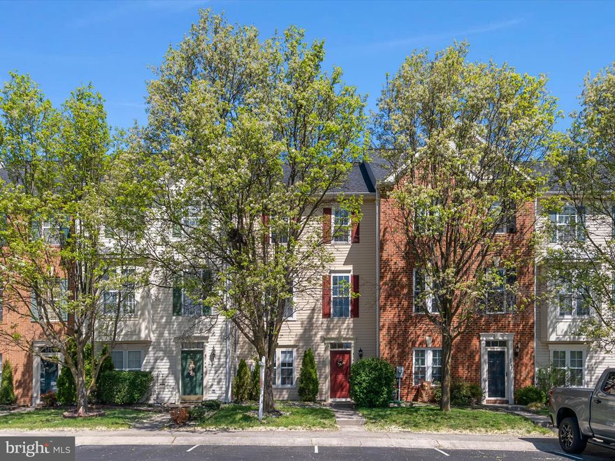 Welcome home to this beautiful townhome with updated kitchen and bathrooms located in the Farmington Village community. Main level boasts wood flooring,  4th bedroom, living space with entertainment area and half bathroom. Sliding glass door will lead you out to the stone patio and fully fenced backyard that backs  up to mature trees. Upper level offers you more living space with an updated kitchen with island and a space for a table. The freshly painted deck is great for entertaining or relaxing with your favorite beverage. The primary bedroom features a walk-in closet and  updated bathroom with stand up shower. The hallway full bathroom features updated fixtures and hardware. The home has been freshly painted with new carpet in the carpet areas. Roof & AC system are new and the water heater is approx. 3 years old. The community amenities include an outdoor pool, community center, tot lots, tennis/pickle ball court and walking trails. Located close to route 100, shopping and dining. Come check out what this home has to offer, along with the amenities of Anne Arundel County!