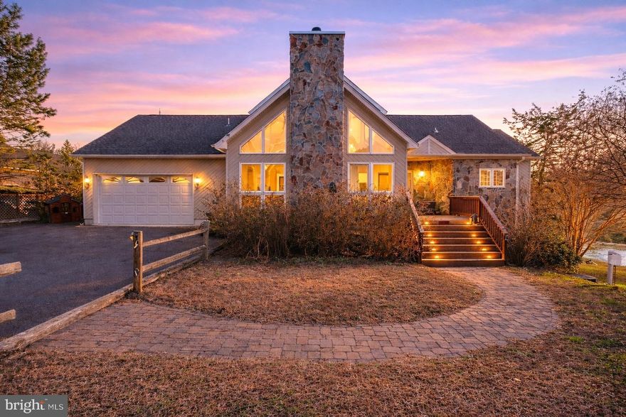 This inviting lakefront home offers the perfect blend of comfort, charm, and breathtaking views. A stunning stone fireplace with gas logs anchors the living and dining areas, creating a warm and welcoming space ideal for relaxing or entertaining. The kitchen and adjacent second living room showcase the home’s most impressive lake views and open seamlessly to a spacious deck and screened porch—perfect for enjoying the waterfront lifestyle year-round.

The generously sized primary suite features a sitting area and beautiful lake views, providing a peaceful retreat. Upstairs, a charming daybed nook at the top of the stairs adds character, along with two additional bedrooms and a full bathroom.

The lower level expands the living space with a third lounge area, game room, fourth bedroom, and full bathroom—ideal for guests or extended stays.

Outside, enjoy your own private beach and a single-slip boathouse with over six feet of water, complete with a jet ski lift. Located in a no-wake zone along the entire shoreline, this property offers safe swimming and water play away from main lake traffic.

Move-in ready and fully furnished, this exceptional lake home truly offers turnkey living—just bring your suitcase and start enjoying lake life.