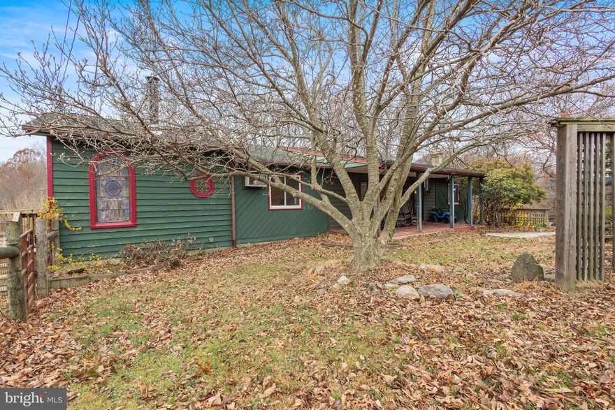 This impressive property offers ten serene acres, striking an ideal balance of privacy and convenience. Located just half a mile from Route 7 and approximately 1.5 miles from the Loudoun County line, the setting feels tucked away while still providing quick access to major commuter routes, services, and nearby amenities. The tree-lined driveway sets a peaceful tone as you approach the home.  The land features a thoughtful mix of open and wooded areas that can support a variety of uses, including areas previously utilized for horses, fenced space for pets, and natural terrain to enjoy. Scenic views of Bear’s Den further enhance the property’s appeal.  Inside, the main level includes three bedrooms, highlighted by a spacious primary suite with a sitting room/office. Additional features include beautiful wood flooring, an updated kitchen with a pass-through window, and a well-appointed primary bathroom. Vaulted ceilings, skylights, and large frameless windows are designed to take advantage of the surroundings, providing stunning natural views. Both the sunroom and the generous primary bedroom offer access to the deck, an ideal place to enjoy seasonal foliage and distant glimpses of the Blue Ridge Mountains.  The lower level provides excellent flexibility with two additional bedrooms, a large recreation room, a full bathroom, and a kitchenette.  A standout exterior feature is the professional-grade greenhouse, complete with its own well pump, heat, backup lighting, and drainage—an exceptional asset for gardening enthusiasts. The expansive detached garage/studio/workshop, situated within the wooded portion of the property, includes electricity and offers a versatile environment for hobbies, equipment, creative work, exercise, or storage. Additional structures include a barn, a pool, three-sided carport with electricity, a garden shed, a woodshed, a chicken coop, and another storage shed, offering ample space for outdoor needs.  This is the one!