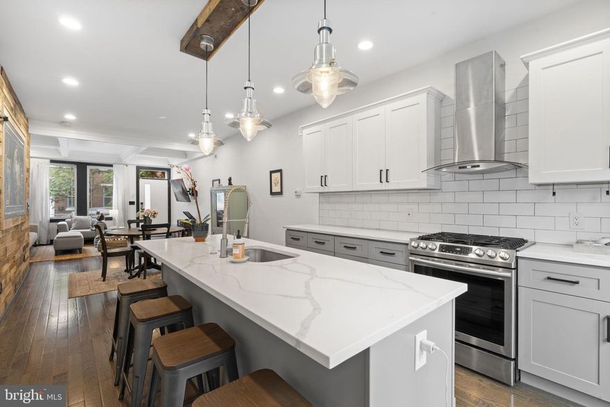 Three-story rowhome in Fishtown featuring a rooftop deck, tax abatement through 2029, and modern finishes throughout.

The main level offers hardwood flooring, coffered ceilings, and strong natural light. The kitchen includes quartz countertops, an island, built-in appliances, and a wood accent wall, with a powder room and basement access just off the space.

The second floor includes two bedrooms, a Jack-and-Jill bath with a double vanity, and a convenient laundry closet. A balcony is accessible from both the hallway and the rear bedroom.

The third-floor primary suite features a tray ceiling detail, a walk-in closet, and an ensuite bath with a double vanity, soaking tub, and glass-enclosed shower.

The pilot house level includes a wet bar and half bath, leading to a rooftop deck with skyline views.

Located on a quiet Fishtown block with ample street parking and convenient access to dining, transit, and neighborhood amenities.