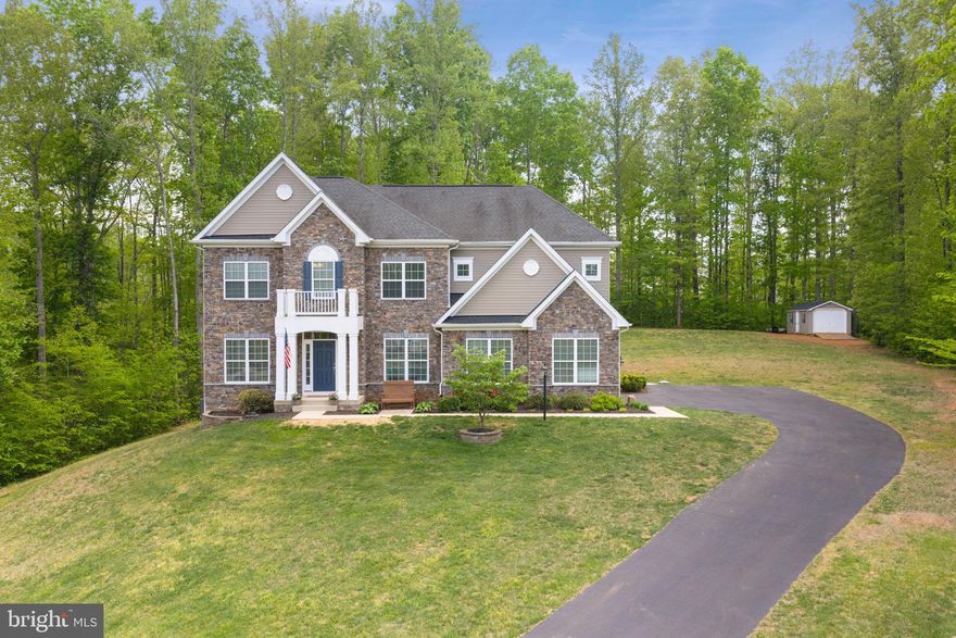 Beautifully sited on a serene, tree-lined homesite, this exceptional property offers the perfect balance of privacy and neighborhood charm. A striking stone façade and timeless architectural details create impressive curb appeal, complemented by a long driveway with ample parking.

The interior features a spacious layout including a large kitchen with a sun-filled table area open to the family room, a private main-level office, a formal living room, and a dining room.

Upstairs, the bedroom level offers a well-designed layout with a Jack and Jill bathroom connecting two bedrooms, an additional bedroom with its own en suite bath, and a large primary suite complete with a separate sitting area, two walk-in closets, and an expansive en suite bathroom featuring a soaking tub, tiled shower, water closet, linen closet, and a dual-sink vanity. A convenient bedroom-level laundry room adds to the home’s functionality.

The finished basement includes a kitchenette-style setup with bar seating, plus a private bedroom with a walk-in closet and an en suite bath, ideal for guests or an in-law suite. Enjoy outdoor living with stamped concrete patios off both the kitchen and the basement walkout.

Enjoy peaceful surroundings with the convenience of nearby shopping, dining, and commuter routes. Residents of Oakley Reserve also have access to a 150-acre wooded retreat, perfect for ATV riding, hunting, or simply enjoying nature.