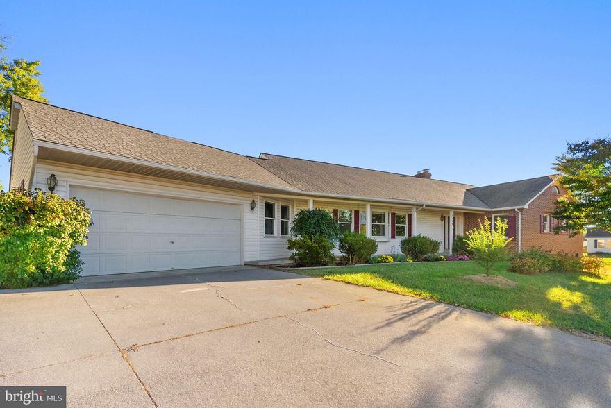 This ranch home located in a quiet Middletown neighborhood is a gem hidden in plain sight and full of surprises. First, it has 4,000 resplendent finished square feet, and second, it offers two levels of independent living. The floorplan flows seamlessly, providing the kind of breathing room you’ll appreciate, enhanced with an elegant color palette, natural light, and stunning hardwood floors that pull it all together. The living room easily provides the space for various seating configurations and offers a fireplace along the main wall to center around. It opens to the renovated kitchen, inviting with its pristine white cabinetry, backsplash, and eat-in island—and where you’ll find ample workspace and storage plus high-end stainless appliances and fixtures. The dining room sits adjacent with space for extras such as china cupboards or buffets. A bonus room affords decent space for an office, playroom, crafts or hobbies, etc. Conveniently
located next to the kitchen, a mudroom combines with the laundry area with storage cabinets and a utility sink. This level boasts four bedrooms and three full baths. The primary suite shines with the addition of a sliding barn door to separate the appealing attached bath plus a walk-in closet. The other bedrooms and baths are all lovely, matching the theme. The downstairs is a complete floor designed as an in-law suite or
rental. It boasts a full kitchen, comfortable living/dining area, bedroom, bath, and dedicated laundry room. The aesthetic matches the upstairs to a backdrop of LVP plank-style flooring. It contains a private separate entrance, and even its own parking. The home rests on .31 acres with a view of the mountains, along with plenty of trees and landscaped shrubs to enjoy. A screened-in porch adds another tranquil respite, as
does a covered porch stretching along the front of the home. A two-car attached garage provides space for vehicles or storage. This home has been updated, renovated, and carefully maintained—and presents a unique opportunity. But also, this residence is the ticket to enjoy Middletown’s quaint, historic downtown, well-rated schools, and peaceful atmosphere plus proximity to Winchester, Shenandoah Valley, and all the area has to offer.