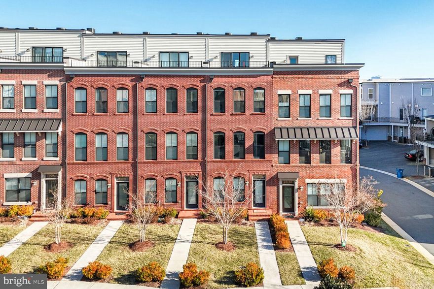 PRICE IMPROVEMENT!! Welcome to this beautifully maintained 4-level townhome which includes 3 bedrooms, 3.5 baths and two outdoor spaces in the vibrant Brambleton Town Center. This Fleetwood Model with Roof-Top Terrace was built by Knutson in 2018 and is located steps from all the shops and restaurants Brambleton Town Center has to offer. Step inside to the foyer where you have easy access to your two-car garage (with added storage space and EV charger plug-in) and an additional personal driveway parking spot. As you move to the second level an open concept main floor greets you and includes your living room, kitchen, dining room and a half bath. Recessed lighting guides you through this level and is a common feature throughout the home. Make lifetime memories by prepping your favorite dishes on the large kitchen island and enjoy an abundance of cabinet space so storage is never an issue. As you prepare your morning cup of coffee, on chilly days nestle next to the gas fireplace in the living room or on warmer days step outside to your personal balcony. 
Moving up the stairs to the third level is where you will find the primary and secondary bedrooms. Your primary bedroom features two walk-in closets, a bump-out for added space and an en-suite with a double vanity and step-in shower. In the hall you will have convenient access to the laundry where a new GE Profile Energy Start Combo Washer/Dryer was installed in 2025. This Combo Washer/Dryer unit allows for ample space to install shelving or cabinetry to store laundry goods and baskets (no more laundry baskets in the bedroom closet!). A south-facing second bedroom and full hall bath finish out this bedroom level. The fourth level includes a loft which can be utilized as an additional entertainment space or home office. Have your guests stay in the third bedroom, which is accompanied by a full bath and shower, or use it as a home office or workout space. Lastly, step outside onto your private rooftop terrace where you can design your outdoor escape to relax, grill or entertain. 
This south facing townhome allows for maximum energy efficiency yet has an abundance of natural light for an interior unit. Additional features include a Dual Zone EcoBee Smart Thermostat and a CuZn UC-200 Under Counter Water Filter (2024). Your monthly HOA dues include Fios Internet and Cable Television, common grounds and lawn maintenance, trash, and recycling services. As a resident of Brambleton Community Association you will be able to enjoy the outdoors with access to five swimming pools, eighteen parks (including Legacy Park, Morning Walk Park, and Creighton West Dog Park), play pickleball at Lake Birchwood, or take advantage of over 18 miles of trails! Brambleton is part of the Little Free Library program and has nine locations around town or visit the Brambleton Library at the Town Center. Venture over to Brambleton Town Center for a full annual calendar of events including Food Truck Fridays, Local Farmer’s Markets and the Brambleton Spring Fling or travel a short distance to The Barn at Brambleton for Live Music! Brambleton and this community is minutes to the metro and Dulles International Airport. Come visit and see why this townhome in Brambleton should be the next place you call home!