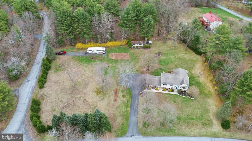 Move in ready 4 bedroom 2 full bath home on a bright open 1.48 acre corner lot! Living Room features cathedral ceilings and hardwood floors. Renovated kitchen with an abundance of cabinets, custom drawers, granite counters. The finished walk-out lower level family room and bar is perfect for entertaining. And has the 4th bedroom and 2nd full bath. Central AC and a Wood stove to keep cozy and keep your utility costs low. Enjoy the view seasonal views from the large living room windows in the front. And the privacy of the large tree-lined backyard from the covered deck and covered patio. Plenty of parking from the long paved driveway, 2 car attached garage, second driveway and detached 1 car garage. Small neighborhood, Conveniently location with easy access to Route 33 or Route 80, and close to two parks, the school, shopping and quaint town. Ask how to receive a $3,000 lender credit towards closing costs or lowering your interest rate!