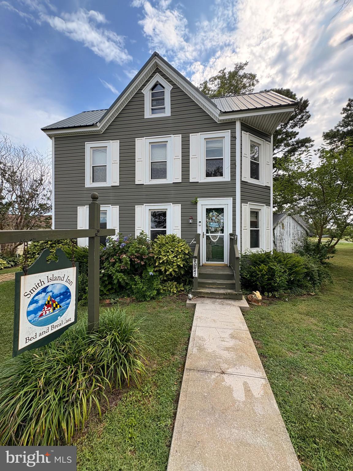 Welcome to the enchanting Smith Island Inn! This one-of-a-kind listing is a well-maintained, established turnkey bed and breakfast business that is ready for new ownership. Located in the center of idyllic Ewell, Smith Island, Maryland, it offers quaint, simplistic charm with high quality service. Proudly featured in many top publications; Baltimore Sun, New York Times, Washington Post, Coastal Living Magazine, Southern Living Magazine, Outside Magazine, and National Geographic Magazine as one of the top places to stay/visit. With Verizon's 5G Internet Service, the current owners are available for training and granting website access to continue in the success of the business. It has many updated amenities while at the same time retaining the original charm of its 1900s structure. You will walk on original pine flooring and the stair casing, both retained and restored to their natural grandeur. Each of the three bedrooms have their own private bathrooms with custom tub/showers. The home features integrated smoke alarms, new 200-amp service panel upgrade. The plumbing, roof, windows, and siding have all recently been replaced as well. There is extra insulation between the first and second floors for noise reduction. Off the large, fully equipped kitchen there is a spacious pantry and laundry room with a half bath. All Bedroom and Living Room Furniture included. Outside water views from the lavishly landscaped yard, enjoy additional seating under a pergola with bistro lighting. A pathway leads to a screened in, all vinyl clad gazebo for dining alfresco. You will also find two sheds for additional storage. Guests are thrilled to immerse themselves in the rich culture of the island; Kayaking, bicycling, walking, fishing, crabbing, birdwatching or just experiencing the simplicity of their surroundings. This is a chance for you to own a slice of Smith Island Heaven. As an added bonus, a 25 foot C Hawk cabin cruiser boat included with a full price offer! A perfect way to spend your days, owning an established successful business, meeting and entertaining folks while at the same time experiencing a peacefulness that only Smith Island has to offer!