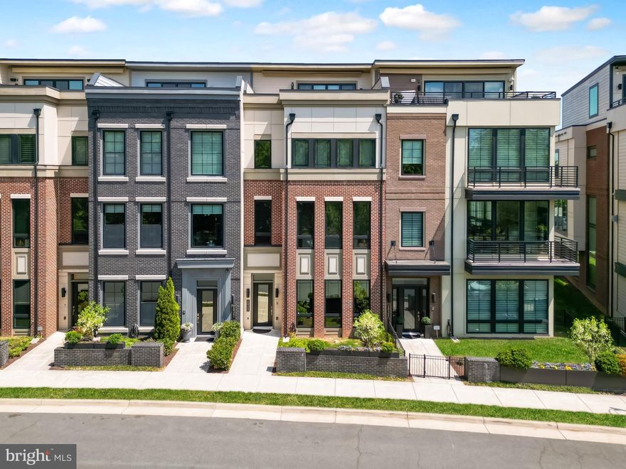 Experience the perfect balance of suburban and urban (Surban) living in the heart of One Loudoun with this unique, park-facing Miller & Smith townhome offering over 4,300 square feet across four impeccably designed levels.  This expansive residence features a private elevator, rooftop terrace, and unobstructed views of the community park, delivering the feel of a luxury single-family home with the convenience of a walkable, vibrant lifestyle. With 5 bedrooms, 4.5 upgraded baths, and multiple flexible living spaces, the home is ideal for multi-generational living, private home offices, fitness areas, or guest accommodations. Furthermore, One Loudoun offers resort like amenities as well as lawn care to bring even more convenience and elevated lifestyle.  

The main living level showcases a sun-drenched open-concept design with soaring 10+ foot ceilings, wide-plank engineered hardwood floors, and seamless flow between the living, dining, and kitchen spaces. The chef’s kitchen is thoughtfully appointed with Wolf Professional appliances, a Sub-Zero refrigerator, quartz countertops, an expansive island perfect for entertaining, and a walk-in pantry with abundant storage. Step out to the private balcony for effortless indoor-outdoor living with gas line ready for grilling.

The third-level has 10 foot ceiling, primary suite that offers tranquil, tree-lined park views and serves as a true retreat, complete with a spa-inspired bath featuring a soaking tub, oversized walk-in shower, and a custom walk-in closet. The hallway bathroom has two vanity with a tub and direct access from one of the two other bedrooms. The laundry room is conveniently located on this level with a linen closet, soaking tub and the washer and dryer that sits on a pedalstool for easy use.

The fourth-level has a bedrooms, a generously sized walk in closet, full bathroom with shower, a loft area that can be used for gym, media, or recreation space that opens to the stunning rooftop terrace perfect for entertaining, grilling, or enjoying sunset views over Central Park.  A powered awning will provide shade in the afternoons.  The terrace also has gas line hookup ready, water hose, outlets ready for fire pit, gardening, and/or wall mounted TV. 

The entry level has 11 foot ceilings, access to front door, garage, mud room, coat closet, and a niche under the stairway for creative functionality. The large versatile room with double glass door is ideal for a bedroom, office, or flex space, along with a full bathroom with a bathtub. The elevator services all four floors. This home is ADA compliant and enhanced with smart home doorbell, door lock, thermostat, security, and whole-home connectivity options. Additional upgrades include Anderson black-framed windows, dual high-efficiency HVAC systems, and premium finishes throughout.

Located just steps from One Loudoun’s renowned dining, shopping, entertainment, and community amenities including parks, trails, clubhouse, pool, and year-round events, this home offers a true live-work-play lifestyle in one of Northern Virginia’s most sought-after communities.