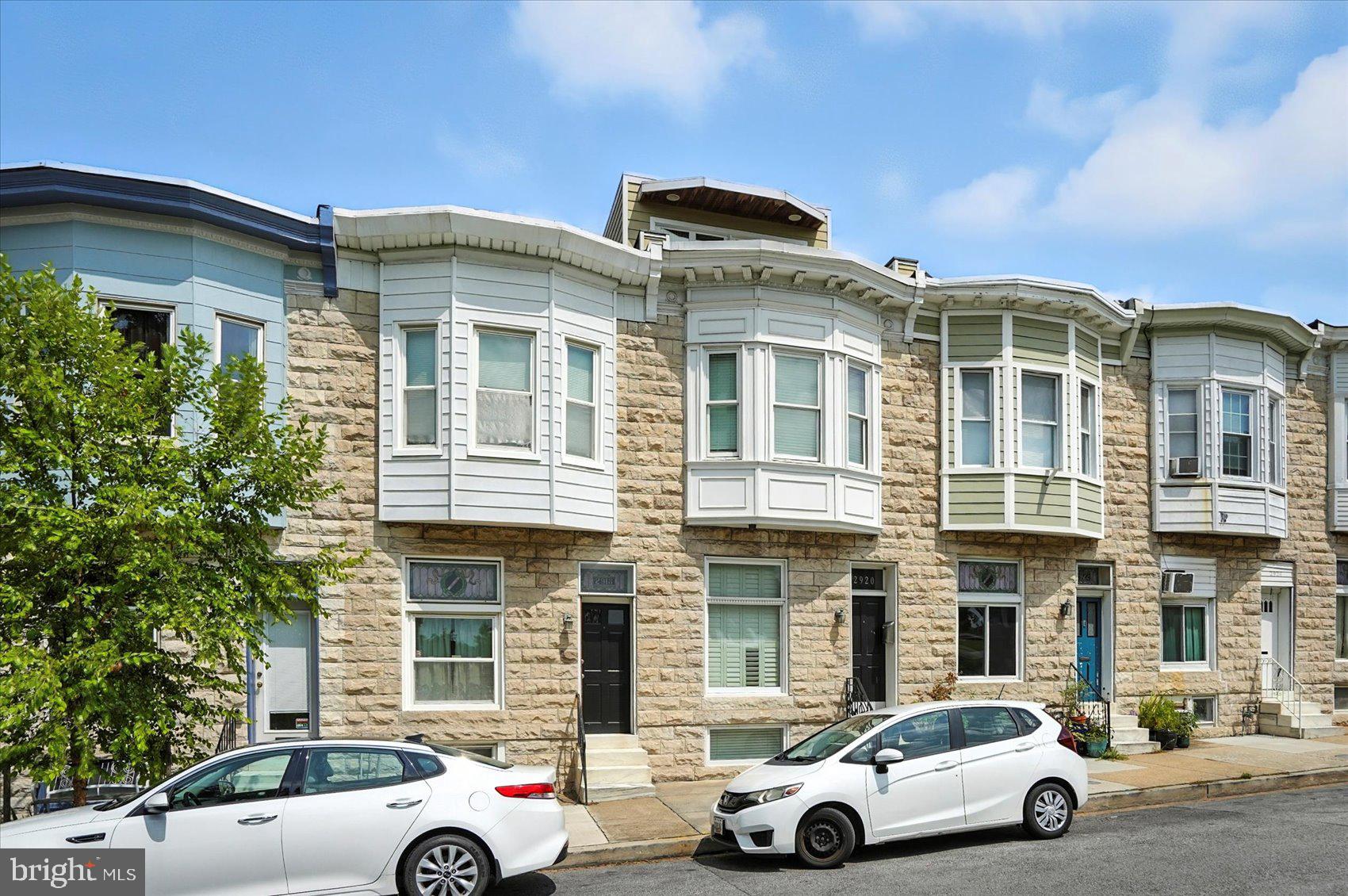 Experience the pinnacle of city living with this custom-designed 3-bedroom, 3-bathroom row home directly facing Patterson Park. The top-level owner’s suite—part of a third-story addition—offers panoramic park views that elevate daily living. Entertain effortlessly with a 20-foot ceiling in the dining and kitchen area, where a four-panel folding glass wall seamlessly connects the interior to a private patio, creating an extraordinary indoor/outdoor living experience.
Inside, designer finishes abound—from a handcrafted iron staircase railing and hardwood floors to a tiered crystal chandelier that steals the spotlight in the dining room. This one-of-a-kind home also features an intercom system, built-in surround sound, and thoughtful touches throughout, blending luxury and functionality in perfect harmony.