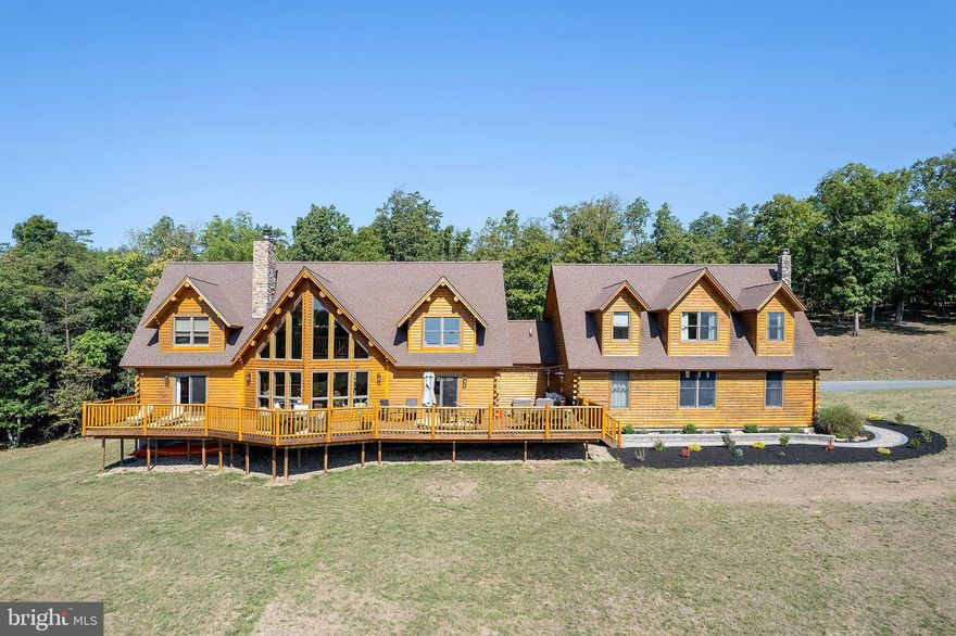 MOUNTAINEER MANSION.....MASSIVE CUSTOM LOG HOME ON 24 PRIVATE UNRESTRICTED ACRES WITH PLEASING SOUTHEASTERN VIEWS OF MIDDLE RIDGE. BEYOND WELL APPOINTED WITH THE HIGHEST QUALITY FINISHES AND MATERIALS, THIS HOME LACKS NOTHING! GRANDIOSE EXPOSED BEAMS, TOWERING STONE FIREPLACE, WIDE PLANK WHITE OAK FLOORING THROUGHOUT, MARBLE COUNTERS, CUSTOM SHOWERS, ETC.....MASTER SUITE ON MAIN LEVEL AND 2 SUITES ON THE UPPER LEVEL. CAREFUL WHO YOU INVITE TO STAY BECAUSE THEY'RE NOT GONNA WANT TO LEAVE.....HUGE SELF SUFFICIENT APARTMENT ABOVE THE GARAGE, PERFECT FOR THE IN LAWS, ADULT CHILDREN, NANNY OR CARETAKER. OVERSIZED HEATED 3 CAR GARAGE COMPLETE WITH MAN CAVE.....I'M RUNNING OUT OF ADJECTIVES FOR "BIG".....OVER 8000 SQ FT UNDER ROOF WITH NEARLY 5000 SQ FT OF FINISHED LIVING SPACE! NEED MORE SPACE? 2200 SQ FT IN THE BASEMENT IS FRAMED OUT AND READY TO BE FINISHED, EASILY ADD A FEW MORE BEDROOMS AND A BATH. EASY TO GET TO BUT HARD TO FIND, ONLY 1/4 MILE OFF THE PAVED ROAD AND LESS THAN 10 MINUTES FROM THE THRIVING VILLAGE OF FORT ASHBY. GET THAT WAY OUT THERE FEELING WITHOUT BEING FAR FROM ANYTHING......A MERE 2.5 HOURS FROM THE DC BELTWAY. THE LAND LAYS GREAT AND HAS A NICE WET WEATHER STREAM.....PLENTY OF ROOM TO HUNT, SHOOT & RIDE ATV'S. SO MANY POSSIBILITIES.....FULL TIME HOME, WEEKEND FAMILY COMPOUND, BED & BREAKFAST......THIS PLACE SCREAMS VENUE! IF YOU WERE STARTING FROM SCRATCH, THIS IS A 2 YEAR, 2 MILLION DOLLAR PROJECT.....WHY PUT YOURSELF THROUGH THAT WHEN YOU CAN HIT THE "EASY BUTTON" AND HAVE IT TODAY!