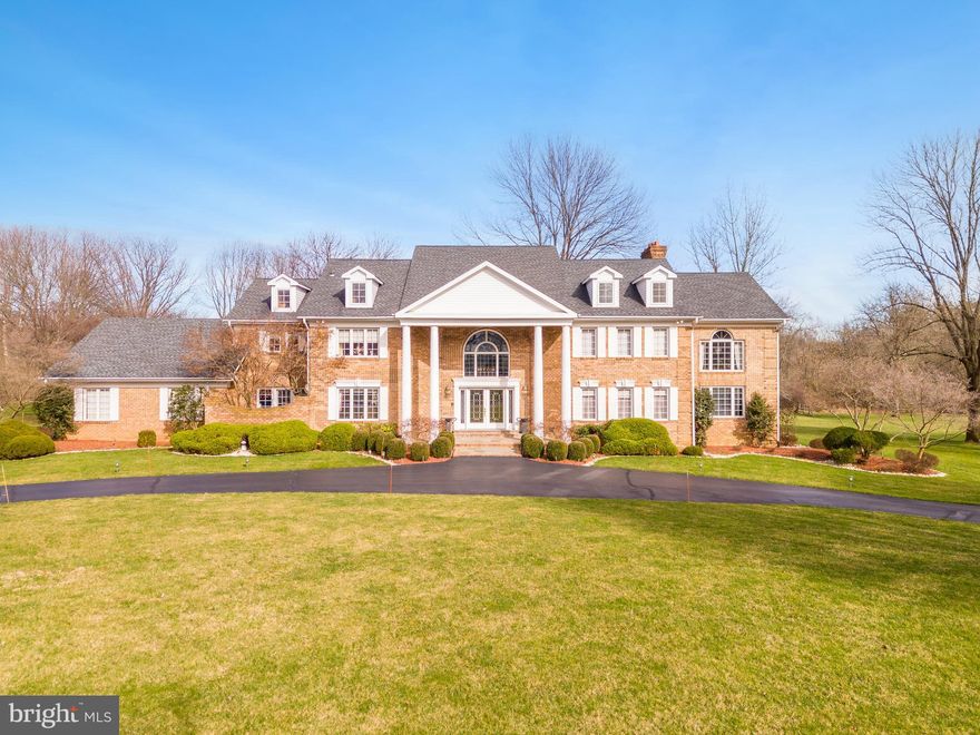 Welcome to 617 Creek Lane, a beautiful 5 bedroom, 4.5 bath brick colonial on 1.82 picturesque acres in Country Club Estates in Whitemarsh. As you step through the double entry doors, you're greeted by a grand 2-story foyer and beautiful curved staircase inviting you into the home. The first floor offers a functional layout, with a formal living room featuring intricate crown molding and hardwood floors that leads you directly into the private office, complete with a wall of built-ins and doors to the slate side patio. The formal dining room is flooded with light from large windows, and opens to the spacious eat-in kitchen, offering an island with barstool seating, a 5-burner stove, double ovens, and sunlit breakfast area with doors to the spacious rear deck - perfect for al fresco dining. Entertain family and friends in the two-story bar room, highlighted by floor to ceiling windows, wet bar, island, and built-in beverage and wine refrigerators. The family room exudes warmth with a gas fireplace framed by a grand mantle and french doors opening to the second deck. The first-floor guest bedroom is tucked away down the hall, offering a walk-in closet, a private picturesque brick courtyard, and access to the full hall bath. A half bath and three-car garage complete this level. Upstairs, a large landing area with tray ceiling and balconies overlooking the first floor leads to the primary suite and guest bedrooms. The primary bedroom is a sanctuary, featuring a gas fireplace, built-in armoire and vanity, double walk-in closets, and a lovely private deck that will become a favorite place to enjoy a morning cup of coffee. French doors open to a private sitting room with wet bar and double closets. The spa-like bathroom offers a double vanity, skylight, jetted soaking tub, and separate shower room with water closet. Three additional guest bedrooms, one with an en-suite bathroom, offer ample space and comfort. A hall bath and convenient second floor laundry room complete this level. The basement, unfinished and awaiting your personal touch, offers ample space for storage or customization.
The rear yard backs seamlessly into Wissahickon Valley Park, providing dense greenery that will never be developed. The multiple rear decks, meticulous landscaping with mature trees and large, flat yard will become favorite places for warm weather entertaining and summer BBQs, and are just a few of the many highlights of this impressive home. Centrally located in the award-winning Colonial School District next to the Green Ribbon Walking Trail and Fort Washington State Park, close to major highways, and just a short drive to the shops and restaurants of Flourtown and Chestnut Hill. Don't miss the opportunity to make this exceptional residence your own. Schedule your showing today!
