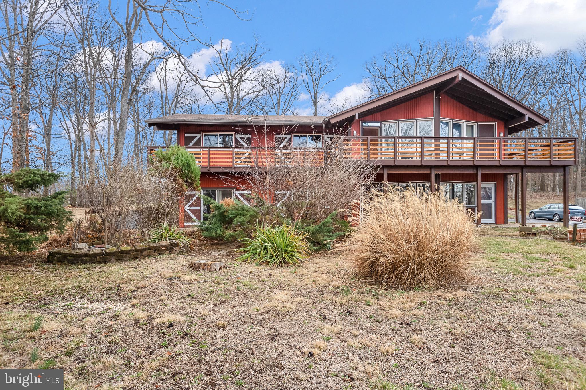 You will not find a more true to form restored mid-century than this home. This mid-century lodge style home is perched high in the forested Braddock Heights outside of Frederick, MD and is an entertainers dream. The quiet lot is replete with mature well kept landscaping. The house features a wrap around deck that’s perfect for outside entertaining. Through the front entrance, you are greeted with a large open sunken living room complete with wet bar and a timber framed cathedral ceiling finished out with floor to ceiling windows. The exquisitely preserved 1960’s ceramic tile extends throughout the living room while the dining rooms and kitchen enjoy hardwood floors. Yes, you have two dining room options for a formal and informal dining room or however suits your needs. The more quiet of the two shares a large three sided brick fireplace with the kitchen. The brick fireplace is finished off with a copper surround. Both dining rooms have direct kitchen access. The galley kitchen has been carefully restored with period matching cabinetry and countertops and is bright with walls of windows looking out into the backyard. All the modern conveniences for the cooks are here along with voluminous storage space. Down the hall from the kitchen are three bedrooms including the master. You will continue to find period items in the designs of these rooms from the cathedral ceilings to the unique windows and blinds. The master bedroom features a large sleeping area that enters a large dressing area, not just a walk-in closet! Through the dressing area you’ll find the Master Bath with double vanities and shower. The guest bath has been updated but still retains many of unique features. Downstairs is the massive basement with an additional 2 BRs, a large family room, laundry with a huge folding area and entrance to the two car garage with huge amounts of storage space. The beautiful backyard has large native trees mixed with exotic and other landscape elements to bring the design ascetics of that era to the outside. Don’t miss the chance to enjoy mid-century style with the conveniences of Frederick minutes away. Easy access to US 15, US 340, I 70, I 270, & MARC, shopping, dining, and outdoor recreation!