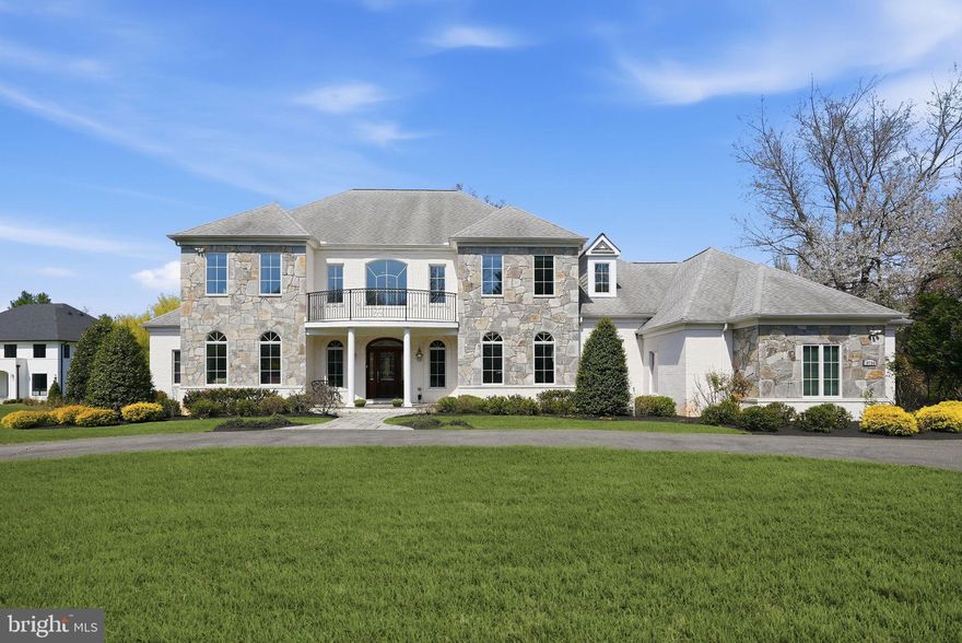 Welcome to this custom-built 2012 residence in the heart of Potomac, offering 11,039 square feet of refined living space on 1.57 acres. A sweeping horseshoe driveway sets the stage for a grand arrival, leading to a custom front door and a stunning two-story marble foyer. From there, the home opens to an elegant living room with a gas fireplace and a double-story coffered ceiling with nine-panel detailing. Palladian windows and glass doors line the rear of the home, flooding all three levels with natural light. Entertain with ease in the formal dining room. The gourmet kitchen is thoughtfully appointed with a large island, breakfast room, and walk-in pantry. The great room features 12-foot ceilings, a dramatic two-tier tray ceiling, and a striking stone fireplace. The inviting sunroom offers year-round enjoyment. The main-level owner’s suite is a private retreat, complete with his-and-hers bathrooms and oversized custom walk-in closets and private terrace. The upper level features four generously sized en suite bedrooms, along with a spacious sitting area on the landing. Designed for convenience, it also offers an additional upper-level laundry with a pre-installed hook-up. An expansive walk-out lower level designed for entertaining, complete with a full bar and home theater, plus a private en suite bedroom and a versatile gym or craft room.  An added bonus—additional unfinished spaces offer endless potential for customization. Outdoor living spaces can be enjoyed from every level of the home, featuring a serene Zen-inspired backyard with a lilly pond, waterfall, walking bridge, and a brick patio for al fresco dining. Ideally located within walking distance to the C&O Canal and a short drive to the nation’s capital!
