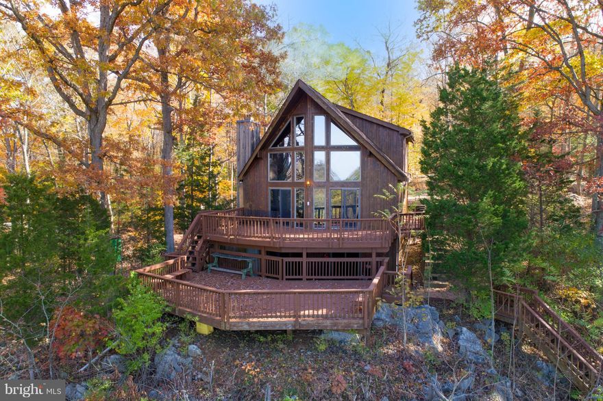 Private river access and breath-taking views in a large A-Frame.  Enjoy year round access to deep water Potomac River.  Dual master setup, main level bedroom, loft bedroom en suite and walk-in closet.  Large kitchen with new granite countertop.  Potential third bedroom in the basement.  Tiered decking suited for hot tub overlooking the water & C&O Trail.  New roof in 2014. Detached garage in 2015.