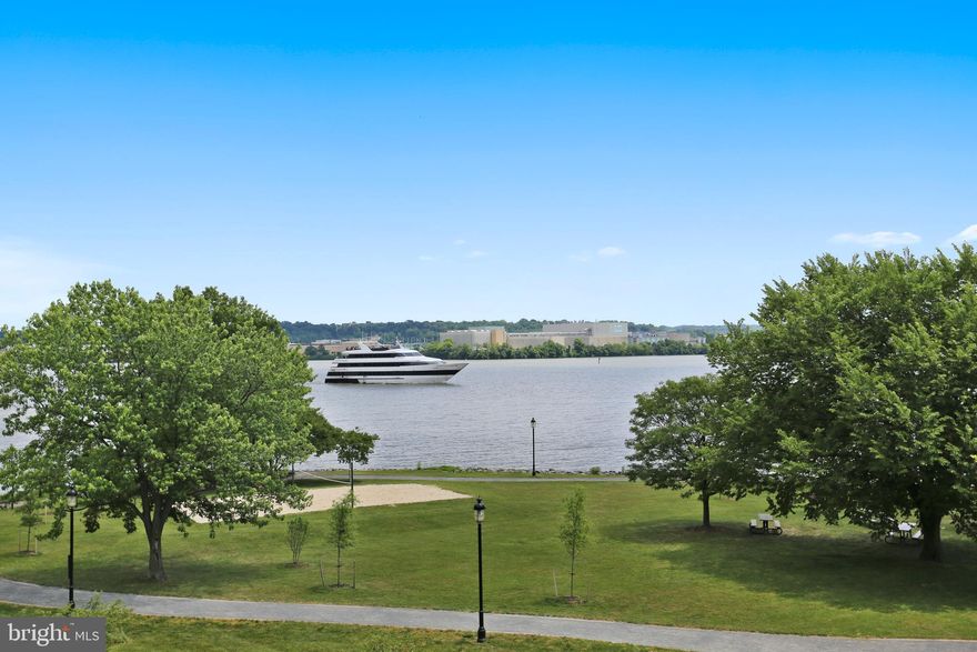 EXCEPTIONAL VIEWS OF THE RIVER & THE PARK FROM THE LARGEST WATERFRONT MODEL-THE SNOWDEN MODEL- AT RIVERGATE. It is like a moment taken straight out of central casting. As you step inside you will be immediately taken with the numerous upgrades and custom details.  The elegant living room welcomes you with custom bookshelves flanking a gas fireplace and flows effortlessly into the dining room.  The open kitchen family room, with a second gas fireplace, over looks over the park and the Potomac River.  The custom white kitchen was designed in 2016 by Cherry Hill Cabinetry and is highlighted by the beveled subway tile backsplash and quartz counters.  The Wolf Range and Sub Zero refrigerator were chosen with the discerning chef in mind.  You can enjoy a lovely spring or summer evening on the patio, with a custom retractable awning,  overlooking the stunning views.  As you ascend the stairs to the second floor the beautiful hardwood floors continue throughout the house.  The master suite with its large and elegant sitting room is truly an oasis with French doors overlooking the park and the river.  The spa like master bath has been updated with a custom vanity with a quartz countertop. A second bedroom and full bath along with the convenient laundry are also found on this level.The 3rd level offers an elegant,light filled guest suite with a cathedral ceiling and private bath.  There is also wonderful storage, to include a cedar closet.The lower level is accessed both from inside the house and by way of the large 2 car garage.  There you will find wonderful built in cabinetry to include a desk area along with bamboo floors.  There is also a 4th full bath on this level.