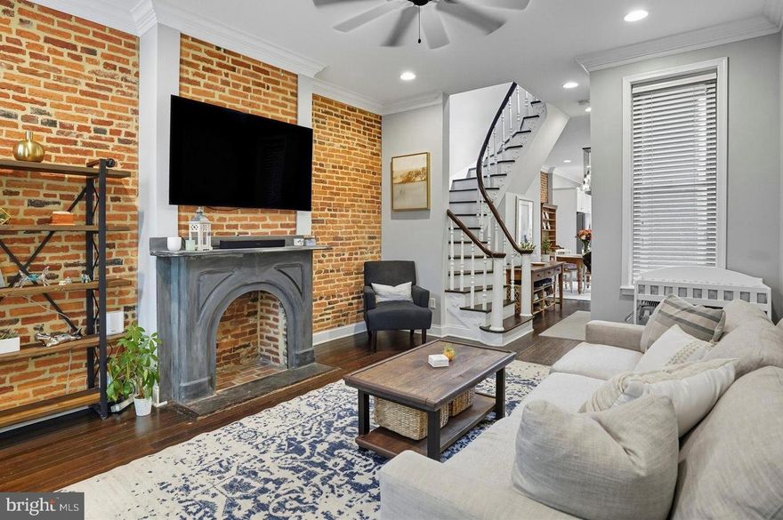 This charming and spacious EOG townhouse in the desirable Upper Fells Point neighborhood offers a perfect blend of historic elegance and modern convenience. Fully renovated in 2015, this home features 3 spacious bedrooms and 3 full bathrooms. Step inside to discover beautiful hardwood floors, a graceful curved staircase, exposed brick walls and a decorative mantle that adds character to the large living room. The heart of the home is the kitchen and dining area, showcasing white shaker cabinetry, upgraded countertops, stainless steel appliances and ample room for a large dining table. The 2nd floor includes the primary bedroom and private bath, large secondary bedroom, hall bath and access to the large roof deck with skyline views. The lower level includes the 3rd bedroom/office or family room with high ceilings, the 3rd full bath, laundry closet with stackable front-loading washer and dryer, large custom storage closets and 2 windows.  The home features recessed lighting, exposed brick, plantation shutters on some windows, neutral paint colors, side windows and a back patio.  Charming Upper Fells Point offers walkability to neighborhood restaurants and pubs, close proximately to John Hopkins Hospital, Downtown, Patterson Park and the Fells Point waterfront.  This home offers an excellent layout and timeless design finishes!
