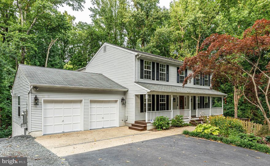 Looking for a 5 bedroom, 3 full and 2 half bath home on an amazingly PRIVATE 1.75 ACRE lot that backs to woods and is simply breathtaking? This exceptional home has almost 4000 ft² of finished living space and is certain to please! You'll love the full front porch, whether spending a minute enjoying your coffee or tea in the morning or simply watching the wildlife in the surrounding trees. As you enter, you'll notice the beautiful hardwood flooring throughout the foyer and much of the main level and see immediately that this home has been beautifully maintained. There is a formal living room with custom bookshelves, a dining room for more formal gatherings or holiday dinners plus a fabulous open chef's kitchen with a beautiful center island, stainless appliances, granite counters and so much prep space - all of which make this home ideal for entertaining or day-to-day living!  Enjoy casual dining in your breakfast room with a bay window overlooking the treed back yard and spend time in your main level family room (with a wood stove insert for the fireplace and custom built-ins) before choosing to relax at the end of a long day on your HUGE SCREENED PORCH!  The upper level primary suite features a HUGE WALK-IN CLOSET and a primary bath that is something straight out of HGTV with it's dual vanities, free-standing soaking tub and incredibly spacious shower. A full size washer and dryer off the primary bath for convenience and ease of living! There are 3 additional bedrooms on this level plus a renovated hall bath with dual sinks and a skylight for wonderful natural light!  The lower level is fully finished with a TRUE 5th bedroom, an office/den, a rec room measuring 21 x 12 plus an additional area that is 16 x 11. This level has laundry hookup, both a full bath and half bath plus walks out to the ground level patio (complete with a fun outdoor shower!).  If you had a home office, this could be the ideal space to meet clients as they would not need to access your main living area!  The OVERSIZED 2 CAR GARAGE measures 22' x24' and is great for all of your storage needs!!  Walk into the woods and you can enjoy "firepit fun" in your own backyard, complete with a stone/concrete patio!!  **  HVAC, WATER HEATER replaced in 2021, 2nd WASHER/DRYER HOOKUP added on the 2nd level in 2021 (original still exists in a lower level closet), HALL BATH renovated 2021-2022, SCREENED PORCH added in 2021  **  Located less than 1 mile as the crow flies from the Chesapeake Bay and less than 10 minutes to the Town of Chesapeake Beach where you will find public beaches, delightful marinas, a water park, 3 scenic boardwalks, charter fishing, amazing restaurants and shopping plus the Chesapeake Beach Rail Trail. 9180 Sam Owings Place is also an easy commute to Joint Base Andrews, Washington Navy Yard, DC and Annapolis.  **  ROAD MAINTENANCE AGREEMENT and SURVEY available