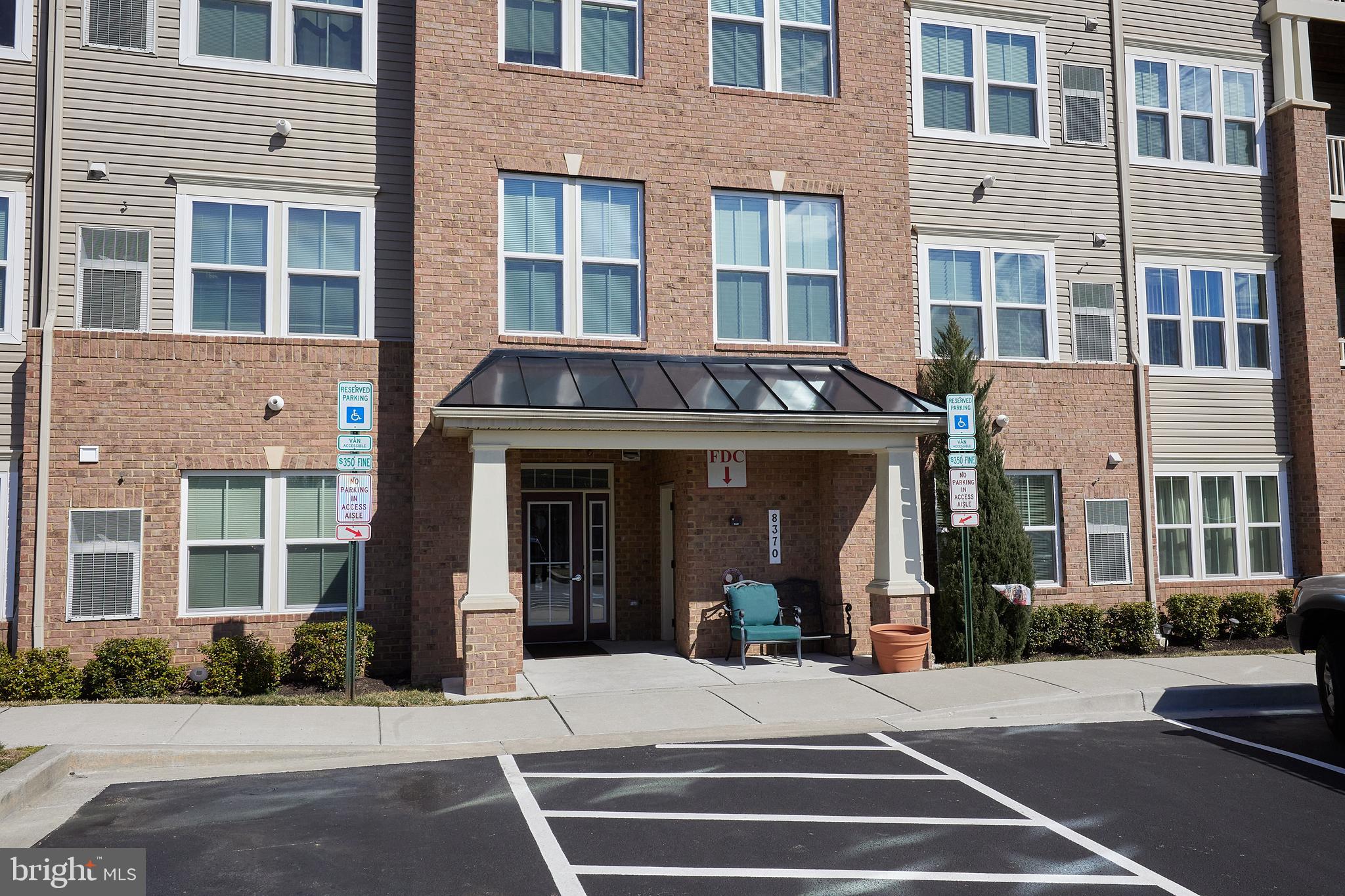 Senior Living at its Finest! Spacious SUN-LIT GROUND FLOOR END UNIT with Patio conveniently located by Parking Lot for Ease of Entry. Open and Light-filled Great Room w/Cherry Floors, Gas Fplc, Built-Ins Open to the Kitchen w/Brkfst Bar, SS Appliances, Cherry Cabinetry and Granite Cntrs. & Separate Dining Area - Large Primary BR w/two closets and Ensuite Bath w/Dual sinks and roomy Shower. 2nd BR at opposite end of unit for Privacy. Large Storage room w/Shelving and In-Unit Washer & Dryer. Slider to Patio plus Side Entry Door for quick access to Parking. Club House w/ Exercise Room, Meeting and Party Rms. In very good condition but conveys "As Is". Subdiv Plat indicates Bldg 10 (subject property) is larger than other buildings and Unit D is listed as 1412 sf more than public records