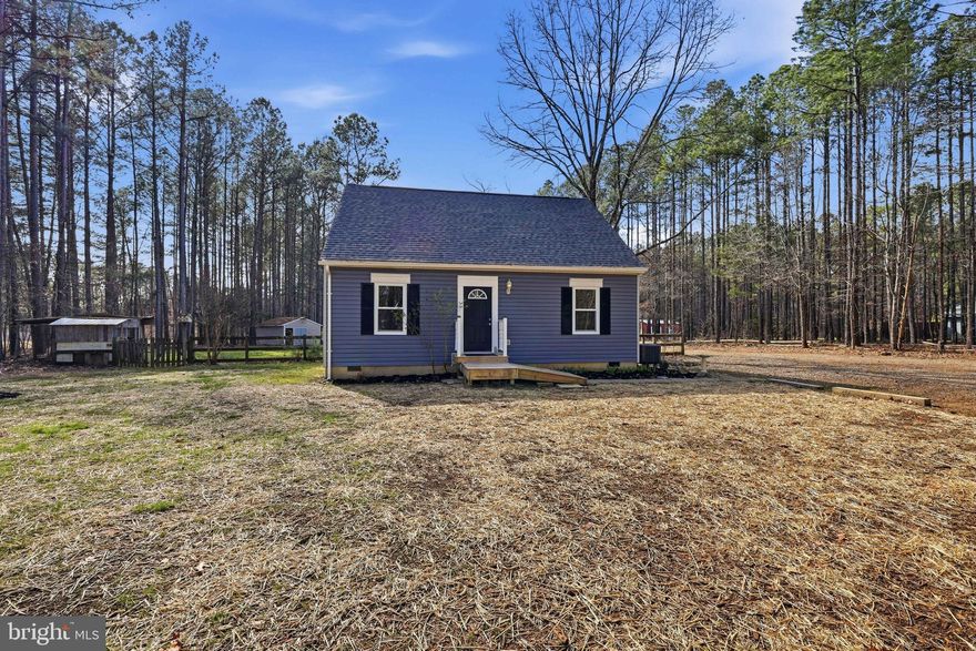 Beautiful 3-bedroom, 2.5 bath home on 5 acres is almost all new and ready for you! New vinyl siding & vinyl windows, new roof, new heat pump, new deck, new flooring and fresh paint. Bathrooms have been updated with new vanities, faucets and light fixtures. All you have to do is move-in. Front door opens into the living room and an archway leads to the eat-in-kitchen with double doors to the back deck – perfect for watching those gorgeous sunsets. Kitchen has lots of cabinets and counter space, a separate pantry, and stainless-steel appliances. The formal dining room can easily be converted for home schooling, crafts, or office space. Laundry room (washer & dryer convey) and half bath complete the first floor. The primary bedroom is upstairs with an oversized closet and attached full bath. There are also 2 other bedrooms and a 2nd full bath. Outside is a large partially-fenced backyard perfect for a pool, playset, or garden plus an existing chicken coop and dog run. Lot is flat and partially cleared. There’s a detached workshop with electricity and a HUGE 4-bay detached garage – ideal for the home mechanic or budding car collector. 10' doors and the ceiling peaks at 15'6". Garage sits on a concrete pad. There's a large fiberglass panel that provides natural light, but the garage has its own breaker panel, lights, and an RV/EV charging plug. Just 10 minutes from swimming and boating at Lake Anna State Park and 15 minutes to shopping and dining at Spotsylvania Courthouse.