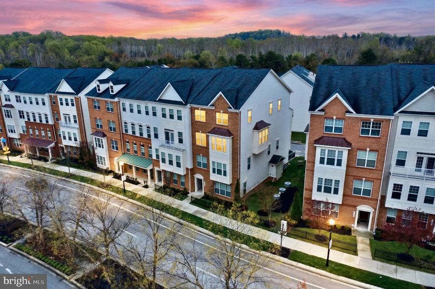 Nestled in the prestigious Oxford Square community, this exquisite end unit two level condo offers a harmonious blend of luxury and comfort. This fantastic, only 9-year young home features over 2,500 square feet of finished space in addition to an attached garage and a private elevator from the entry to the main and top floors! This home is just a short walk to the community pool, gym, outdoor patio with fireplace, community club and meeting houses. Perfect move-in condition with tremendous upgrades, including stunning hardwood floors throughout the main level, oversized windows and tall 9' ceilings. Bathed in abundant natural light and boasting a seamless open-concept combining the kitchen, dining, living room and family room, this home feels expansive and inviting from the moment you step inside. A true dream gourmet kitchen with granite counters, upgraded stainless steel appliances, gas cooktop, wall oven, built-in microwave, subway tile backsplash, 42" cabinets with crown molding, butler's pantry, food pantry and an expansive raised breakfast bar island with pendant lighting. The family room has access to the rear deck creating a bright and open living/dining area. On the opposite end of the main level is a very large flexible space with endless possibilities; living room, game room or office space, ready to suit your vision. A spacious powder room completes the main level. Retreat to the upper level, easily accessible via your own in-unit elevator or the stairs. The primary suite serves as a private oasis highlighted by tray ceilings, massive walk-in closet, atrium door to the 2nd exterior deck, a spa-inspired en-suite bathroom that showcases a massive, luxurious walk-in shower. Two more sizable bedrooms, an additional full bath with dual vanities and very convenient laundry room with built-in storage complete the upper level. Enjoy effortless living with HOA fees covering all exterior maintenance, lawn mowing, snow removal, master insurance policy, community management, pool and amenities. A commuters paradise - minutes to major routes, MARC and Amtrak train line, and BWI Airport.