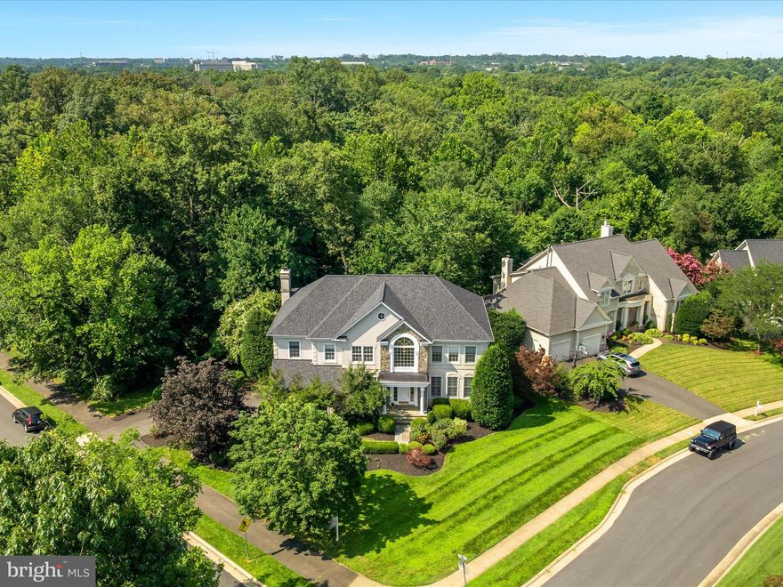 - Open House cancelled as House went Under Contract  - **OPEN HOUSE on SUNDAY, OCTOBER 19 from 12 to 3**  INVITING OPEN FEEL INTERIOR with abundance of Natural Light in Private Setting backing to woods. NEW Roof, NEW HVACs, NEW Appliances, NEW Washer + Dryer, REFINISHED Hardwoods, NEW CARPET, NEW Paint.  Approximately 6,000 sq ft of space plus DECK on .45 ACRE LOT BACKING to over 10 acres of TREED AREA owned by Reston Association & Fairfax County Park Authority. FOUR ensuite BATHROOMS on UPPER LEVEL plus Main Level Powder Room and FIFTH FULL BATHROOM + Bedroom / InLaw or Au pair Suite on WALK-OUT LOWER LEVEL. Main Level OFFICE with Built-Ins plus Spacious rooms including statement Family Room on Main Level provide Flex Living Space options. Serene Owner’s Suite boasts 2 walk-in closets and Coffered Ceiling. Oversized Island in Kitchen with Breakfast Room. Dramatic interior finishes include High Ceilings, dual Staircases, Arched Stone Fireplace, custom Built-Ins, 2 Wet Bars, 2 Fireplaces, Plantation Shutters, 7 Ceiling Fans. Side Load Garage, Decorative Landscaping and Flagstone Walkway to Covered Front Porch, Quoining highlights and stone on exterior. Grand Renoir Floorplan by Renaissance Builders - was Model Home and therefore had additional finishes.  Relaxed setting close to everything including access to over 55 miles of Paved Paths in Reston. Enjoy the Reston pools, tennis, pickleball courts, tot lots, activities+++  Near North Pointe Shopping Center w/Starbucks, Dining, and Giant Food. Moments to Trader Joes, Harris Teeter, Whole Foods, Wegmans. Less the 3 miles to two Silver Line of Metro Stations, Reston Town Center, W&OD Trail. Less than 9 miles to Dulles Airport.