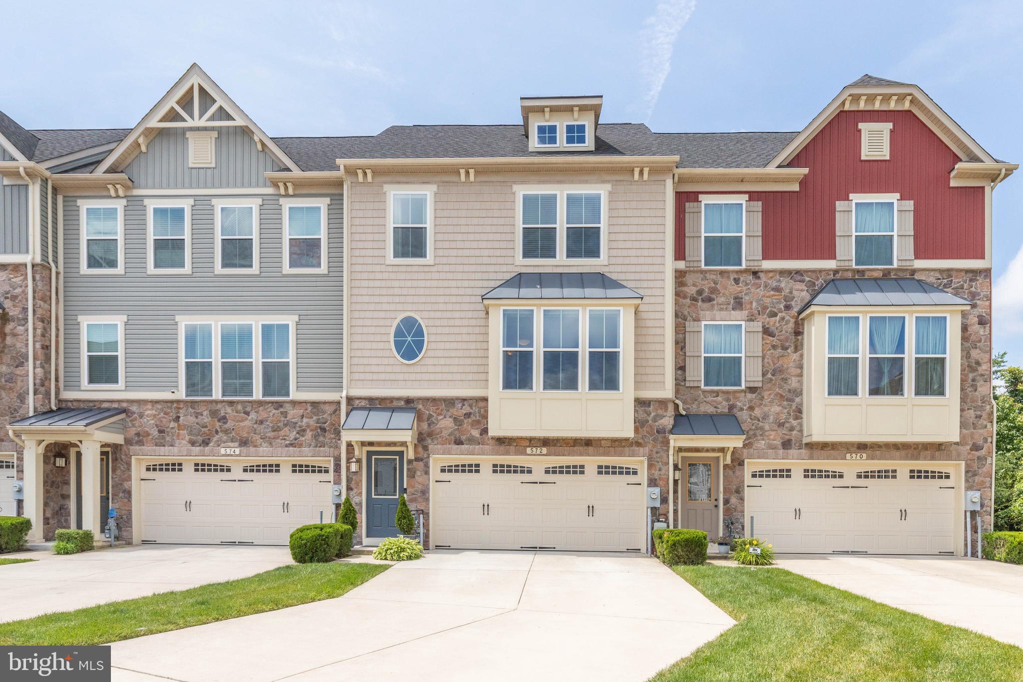 This popular Wexford model is one of the largest townhomes in the community, and it s loaded with upgrades and improvements.The main level boasts premium hardwood floors, upgraded metal balusters, and a living room extension, further enhancing the open-concept look and feel. A stunning built-in wall unit with misting fireplace with supplemental heat creates an atmosphere of warm elegance. The main level leads past the half bath and into the Entertainer s kitchen with recessed ceiling lights, premium granite counters, large center island, stainless steel appliances, a 5 burner gas stove with convection oven, and includes the butler s pantry with glass doors upgrade. Board and batten walls surround the dining area with upgraded overhead lighting.The enormous open kitchen overlooks and leads through to the largest deck permitted by the HOA. Once on the maintenance free deck, you ll enjoy quiet evenings overlooking not only a landscaped and fully-fenced rear yard but there are no rear neighbors. You ll appreciate the sun setting over a lush, mature Sycamores, Maples, Poplars and Pines.The lower level features a fully-finished family room with recessed overhead lighting and ANOTHER misting fireplace. Lower level leads into a completely finished garage with extra storage. Speaking of storage, in the rear yard there s a large maintenance-free storage shed where you can store bulky items keeping the garage neat and clean. Parking is never a problem because in addition to the two car garage, this home has one of the longest and largest driveways in the entire community. Guest parking is directly across the street.All stairways have been enhanced with designer molding and you won t have to contend with mashed-down carpet because all steps are upgraded to hardwood. Upstairs, the spacious master suite offers the upgrade tray ceiling with light kit, plantation shutters on all rear windows, and a luxurious master bath with deep soaking tub, upgraded lighting, separate shower and granite vanity with dual sinks. The third floor is complimented with a second full bath, two additional bedrooms, and a finished third floor laundry (Washer/Dryer convey).Optimally located in the community, the pool, clubhouse and gym are within easy and quick walking distance. Creekside Village is among the most sought-after communities in Anne Arundel County with dog friendly tree-lined sidewalks, low HOA costs and unlike other nearby communities, no front footage fees. View the photos, take the Redfin 3D tour, watch the features video on YouTube (search 572 Fox River Hills Way), then make your move because this home won t last.