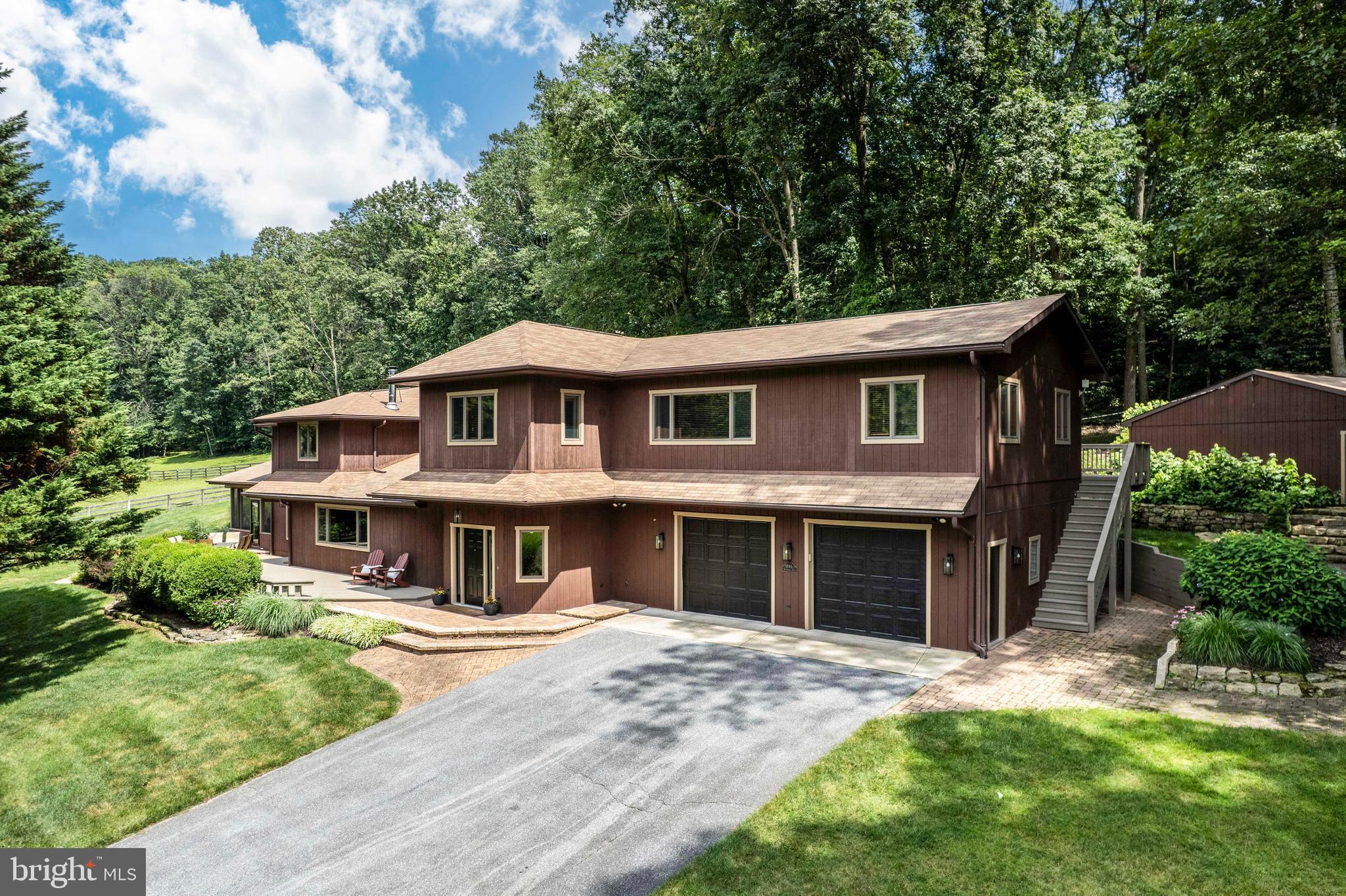 OPEN HOUSE SUNDAY 1-3pm*Welcome to this one-of-a-kind craftsman style home with over 4,700 finished sq feet of carefully designed living space that blends rustic charm with modern updates in a dreamy countryside setting*Truly an entertainer's delight, this home sits on over an acre of meticulously landscaped yard with hand stacked stone walls, multiple decks, E.P. Henry landscape paver patio, & lush perennials which back to mature private trees*Inground turf & landscape irrigation system ensures lush vegetation even in the hottest days of summer*There is also plenty of space for your vehicles, hobbies, or work from home needs with a 2-car attached garage & 3 car detached garage*The oversized asphalt driveway is ideal for a camper or additional vehicles*Home has been meticulously constructed with 2 x 6 framing, stained casement Anderson windows, & T1-11 wood siding*Step inside to discover a warm & inviting main level featuring a stunning open concept kitchen, expansive windows, a light filled 35' x 9' sun room with wood stove, spacious living room that flows into a vaulted ceiling screened-in-porch*The large walk-in pantry with built ins will fit all of your culinary organizational needs*The kitchen boasts Jenn-Air stainless appliances, granite counter tops, stone backsplash, & an island*Also on this level are 2 spacious bedrooms, a full bathroom, & a laundry/utility room with newer Rheem hot water heater*New light fixtures, new high end ceiling fans, real wood shades, new carpet, & high end ceramic tile add to the luxurious flow of the home*Moving onto the first upstairs area, enjoy a spacious bedroom primary suite with vaulted ceilings, real hardwood floors, bonus sitting room, large walk in closet with custom organizers, & a spa like primary bathroom with walk in shower & Jacuzzi tub*The other upper level stairway leads to an entertainer's dream*This section of the home has a great room, wet bar, 2 offices, another dining area, & another full custom bathroom*One of the offices could easily be converted into a 4th bedroom*Off the dining area is another upper level deck overlooking the beautiful rear yard*This is truly a one of a kind opportunity to own a custom tucked away retreat that is only minutes from either Westminster or Manchester*Please note: Major renovation in 2005 adding club room, 2 car garage, foyer, kitchen, & geothermal HVCAC*Tri-zoned geothermal HVAC*Monthly BGE average for 2024 was $384 per month*All framing is 2 X 6 Construction*High yielding well with constant pressure water system*E.P. Henry landscape pavers*In-ground turf & landscape irrigation*Custom Hunter Douglas real wood window blinds*Wet bar with Kenmore mini fridge*Wood Brunswick billiards table with custom gold felt*Most closets come with built-in wood shelving & hanging rods*Please look to disclosures for the extensive unique features list before showing*