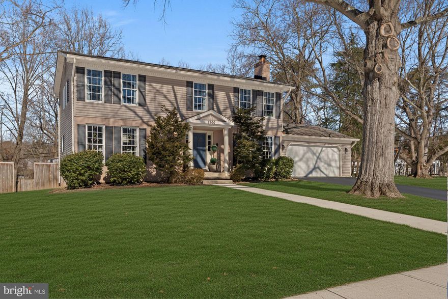 A timeless Colonial reimagined for refined living, this residence offers more than classic architecture—it delivers an exceptional lifestyle. From the moment you enter, rich hardwood floors, graciously scaled rooms, and oversized windows create an atmosphere of warmth, light, and understated elegance. Expansive front and rear grounds provide a serene setting for outdoor entertaining, play, and gardening, all with a sense of privacy and ease.

The living room is bright and inviting, offering generous space for both relaxed evenings and sophisticated gatherings. At the heart of the home, the open kitchen is designed for connection, with room for a breakfast area and effortless entertaining. The dining room opens directly to the rear deck, creating a seamless indoor-outdoor flow ideal for weekend soirées and al fresco dining. This level is thoughtfully completed with a pantry, mudroom, laundry room, and convenient access to the two-car garage. A beautifully appointed bonus room with fireplace offers versatility as a private study, intimate sitting room, or playroom, while an elegant powder room completes the main level.

Upstairs,  there are 4-5 sun-filled bedrooms provide peaceful retreats, including a spacious primary suite with a beautifully renovated en suite bath and potential for an entire room of closet! The lower level extends the home’s entertaining potential, featuring a wet bar and ample space for recreation, gaming, or media enjoyment, along with substantial storage and existing plumbing should a future bath be desired.

Set on nearly half an acre, with a deck just off the dining room and a two-car garage, this exceptional property blends timeless Colonial charm with modern comfort and luxury living.