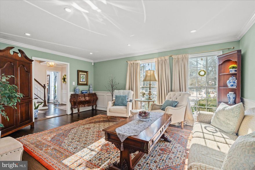 IMPROVED VALUE on this rare and timeless Colonial reimagined for refined living, this residence offers more than classic architecture—it delivers an exceptional lifestyle. From the moment you enter, rich hardwood floors, graciously scaled rooms, and oversized windows create an atmosphere of warmth, light, and understated elegance. Expansive front and rear grounds provide a serene setting for outdoor entertaining, play, and gardening, all with a sense of privacy and ease.

The living room is bright and inviting, offering generous space for both relaxed evenings and sophisticated gatherings. At the heart of the home, the open kitchen is designed for connection, with room for a breakfast area and effortless entertaining. The dining room opens directly to the rear deck, creating a seamless indoor-outdoor flow ideal for weekend soirées and al fresco dining. This level is thoughtfully completed with a pantry, mudroom, laundry room, and convenient access to the two-car garage. A beautifully appointed bonus room with fireplace offers versatility as a private study, intimate sitting room, or playroom, while an elegant powder room completes the main level.

Upstairs,  there are 4-5 sun-filled bedrooms provide peaceful retreats, including a spacious primary suite with a beautifully renovated en suite bath and potential for an entire room of closet! The lower level extends the home’s entertaining potential, featuring a wet bar and ample space for recreation, gaming, or media enjoyment, along with substantial storage and existing plumbing should a future bath be desired.

Set on nearly half an acre, with a deck just off the dining room and a two-car garage, this exceptional property blends timeless Colonial charm with modern comfort and luxury living.