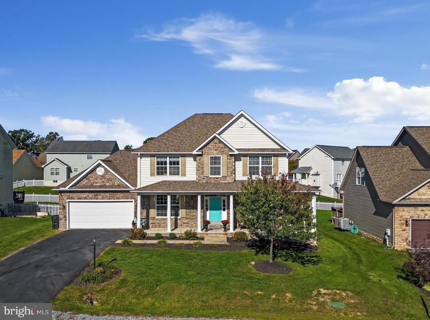 Impeccably maintained and ideally located right off Rt. 51, this 3500 sq. ft. stone-front colonial with fully finished lower level has many recent updates, including beautifully refinished hardwoods that cover most of the main floor. Fresh paint, new black doorknobs and hinges, some new windows, a 5-year-old roof, and a new back door with built-in blinds all enhance this beautiful, single-owner residence. Outside is a large and newly refinished back deck with built-in gas firepit, plus a wraparound front porch accented by professional landscaping. Inside, you’ll find tall 10’ ceilings, a refreshed kitchen with LVT flooring, black stainless appliances and Corian counters, a laundry/mud room with tasteful flooring and built-in storage, a modernized half bath, a formal dining room with tray ceiling, crown molding and wainscoting accents, recessed lighting, and a stunning gas fireplace. The garage even has an epoxy floor and plenty of extra storage space. The lower level with walkup egress entrance is well-appointed with a small second kitchen featuring a sink and gas range, a rec room, bonus room, and even more storage – perfect for multigenerational living. You’ll also find a new water heater, water softener, and sump pump with battery backups. Upstairs are 3 bedrooms with new carpeting as well as a flex space that could serve as an office, workout room, or nursery. The spacious primary suite has a gorgeous tile shower, jetted tub, and walk-in closet. There’s so much to love about this move-in-ready home that’s easily accessible to commuter routes and local amenities. Don’t miss out!