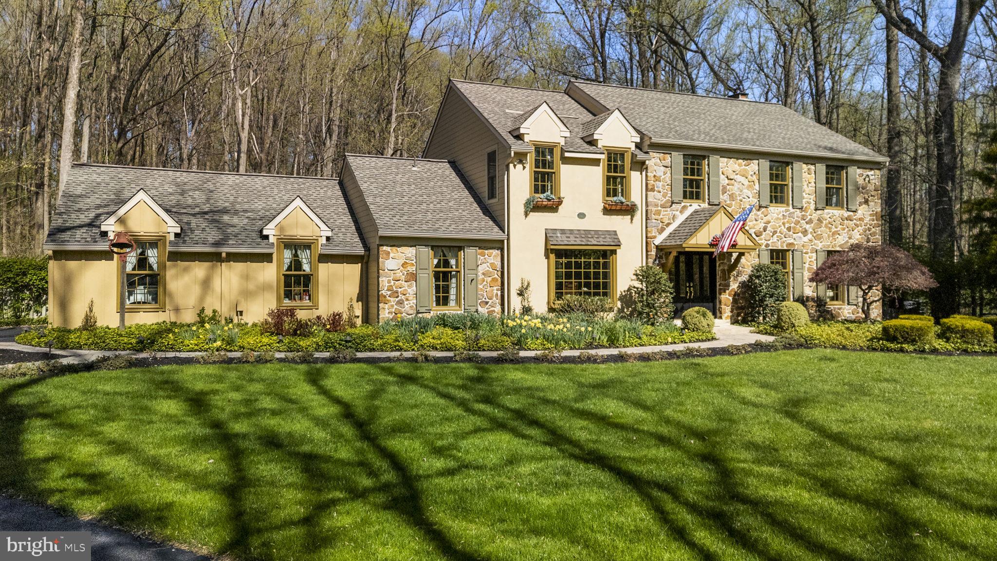Welcome to 1054 Kerwood Rd, a beautifully appointed 4-bedroom, 2.5-bath colonial nestled on a private, professionally landscaped 1-acre lot in the heart of West Chester, PA. Tucked away at the end of a quiet cul-de-sac and backing to the scenic Oakbourne Park, this home offers both privacy and convenience. Built in 1983 and updated with new Hardie-Board Siding and windows in 2018, the home showcases timeless charm and thoughtful updates throughout. Inside, Brazilian Mahogany hardwood floors, crown molding, and elegant wainscoting set a warm and refined tone. The spacious layout begins with a formal living room to the right and a generous dining room to the left, leading to a chef’s kitchen complete with Quartzite countertops, a large island, stainless steel appliances, and a sunlit eat-in area. Just off the kitchen, the bright and inviting family room features a gas-burning fireplace, perfect for cozy evenings. A large office with abundant natural light offers an ideal work-from-home setup, while a pantry, powder room, laundry area, and access to the two-car garage with attic storage complete the first floor.
Upstairs, hardwood flooring continues throughout, including in the spacious primary suite, which boasts a large walk-in closet and a beautifully updated en-suite bath. Three additional bedrooms offer generous space and share an updated hall bathroom. The finished basement adds over 725 square feet of versatile living space, including a large rec room, a second office, a cedar closet, and plenty of storage.
Step outside to discover a backyard oasis featuring a manicured lawn, lush gardens, a large deck, and a spectacular patio surrounding the in-ground saltwater pool and spa, all with serene views of Oakbourne Park. This exceptional home is located just minutes from West Chester Borough, major commuter routes including Rt 202 and Rt 1, the Delaware border, and is part of the award-winning West Chester School District (Rustin High School feeder). With Oakbourne Park Athletic Complex just a short walk away, offering tennis, pickleball, basketball courts, fields, trails, and more, this home truly has it all. Don’t miss your chance to own a peaceful retreat that blends comfort, style, and an unbeatable location.