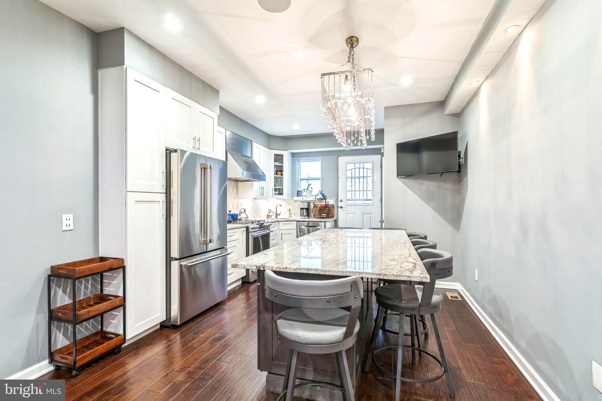 Don't miss out on this Northern Liberties gem! This highly desirable townhome offers a combination of convenience and modern living that is unmatched. Fully renovated in 2019 with modern accents and a stunning chef's kitchen, the home offers a straight-through design that is open and practical.
Located right across the street from Acme, your new home is walking distance from public transportation, as well as the best nightlife in Northern Liberties and Fishtown. Hot spots like The Piazza, Johnny Brenda's, Frankford Hall, Other Half, and The Filmore are all a few blocks away. Critically acclaimed restaurant Laser Wolf is within a 5-minute walk.
A tile foyer and electric fireplace surrounded by elegant built-in shelving welcomes you into the home. From here, walk towards the back of the home to the modern kitchen featuring granite countertops, stainless steel appliances (including GE Cafe fridge and dual-fuel oven), plenty of cabinetry, and a large island, making cooking and entertaining a breeze. The back door is also located here, leading to a patio that's perfect for grilling and al fresco dining. Built-in speakers on the first floor and finished basement make listening to your favorite music a breeze. On the second floor, there are two large bedrooms and a full bathroom. The primary suite is located on the third floor, featuring exposed brick from the 1920s, sconces, and a beautiful accent wall along with a walk-in closet. Included in the primary suite is an elegantly designed full bathroom that dazzles with decorative tile and a rain-style shower head. Also on the third floor is a fourth bedroom, which features a private powder room.
For peace of mind and to improve the longevity of appliances, there is a whole-home water filtration system and water softener. A two-zone HVAC system and whole-home humidifier increase comfort and efficiency. Laundry is a breeze thanks to a large laundry room, complete with shelving and a wash basin in the fully finished basement. Additionally, this property features a Ring doorbell and alarm system.