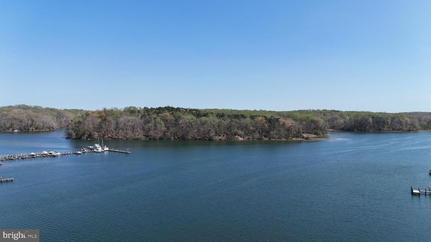 No HOA. Total square footage of 3195, which includes the 1120 sq ft apartment. The house's total sq ft is 2075. Tucked along the protected waters of Saint Leonard Creek, this is the kind of property you don’t just visit, you settle into. Deep water, nearly 800 feet of riprapped shoreline, and over 6 private acres set the stage for a true waterfront lifestyle. The creek opens easily to the Patuxent River, and just across the water sits Vera’s Restaurant, a local favorite you can reach by boat for dinner, drinks, or a relaxed afternoon on the dock. Many people say the Best Crabbs in Maryland are found in St. Leonard Creek, and this pier is a place to find them!
The pier is built for serious water use. New Trex decking gives it a clean, low-maintenance finish. A covered boathouse, multiple slips, floating dock, dock shed, and room to move make this ideal for boaters who want everything in one place. Whether it’s fishing at sunrise or heading out for a cruise, this setup is ready.
The 6.24 acres, five of which are in a Calvert County Forestry Program, has many tall pines, poplar, and other trees , making this property secluded and private. A large three-car garage includes a half bath and is topped by a spacious apartment with a bedroom and a full kitchen. In the garage there's built-in shelving,  3 massive bays, and an air compressor already in place, making it functional for hobbies, storage, or extended stays. This opens up options. Live in the apartment while building your dream home, or use it as a private guest space.
The main home has been well cared for over the years and offers a solid foundation for someone ready to make it their own. You can move in now and update at your own pace without pressure. The large gunite swimming pool was redone in the summer of 2024 by the original contractor, Stevenson Pools.  Aquapro Pools is installing a new automatic pool cover, bringing a polished finish to the backyard setting.
Additional outbuildings include a machine shed and a smaller shed, giving you room for equipment, projects, or expansion of how you use the land.
Location matters here, too. You are minutes to Broomes Island, Solomons Island, and local marinas. Easy access to Route 4 keeps commuting to Prince Frederick, Annapolis, DC, or Pax River within reach while still feeling completely removed once you are home.
This is not just a house on the water. It is space, shoreline, and flexibility. Use it as it stands, reimagine it over time, or build something entirely new. Properties like this do not come along often, especially with this kind of frontage and deep water access.