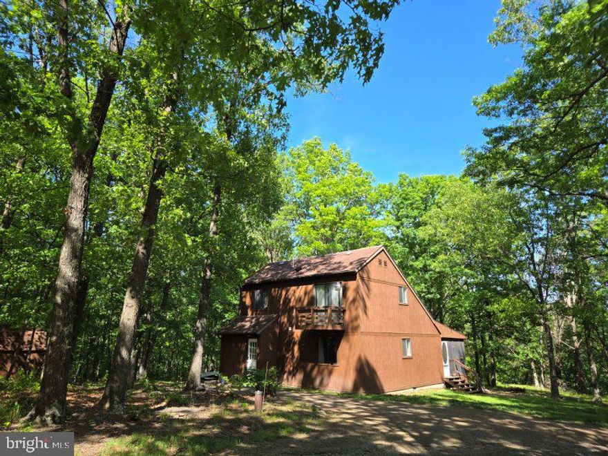 Very Private setting with 5.45 unrestricted acres.  Come check out this lovely home with upgrades including tile and laminate flooring, bathroom vanity and new stone flooring under woodstove.  Baseboard heaters were replaced recently, and the AC unit is only 2 years old.  Enjoy the mornings and evenings sitting on the screened in back porch.  Master bedroom on main floor with 2 bedrooms on the upper level with a jack n jill bath.  The attic insulation and crawl space vapor barrier were replaced in June of 2022. Enjoy the outdoors with electric hookups and hot and cold spigots. Blackberry bushes, wet weather stream and wildlife everywhere. This lovely home is located only about 6 miles south of Berkeley Springs and only 4 miles to the beautiful Cacapon State Park... OH and we can't forget the seller is offering a home warranty.