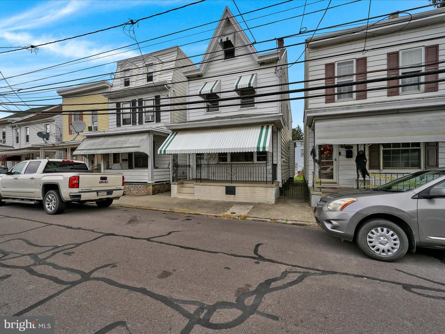 Welcome home to St. Clair Borough! This charming single-family residence has great curb appeal, featuring front awnings and a welcoming covered porch. Step inside to discover the character of the first floor, where hardwood floors flow through the combined living and dining rooms and a graceful arch divider defines the space. The main level is completed by an eat-in kitchen located at the rear, offering access to a convenient side enclosed porch—ideal for a mudroom. Upstairs, you'll find three comfortable bedrooms and the full bath. The bathroom has been thoughtfully designed with nice cabinetry and built-in storage. Thanks to the easily accessible walk-up attic and full basement storage will never be an issue here. Outside, the nice back yard offers some green space and off-street parking for up to two cars. Schedule your tour today!