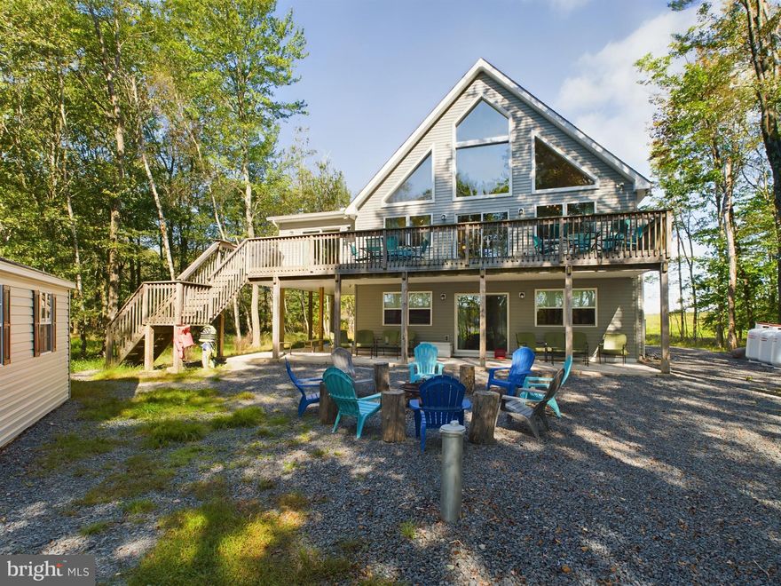 Location!!! Location!!! Nestled between two lakes, this 6 bed, 4 bath Lakefront Chalet not only has lake access but has a beautiful view of the North Arrowhead Lake as well. Located in the amenity-filled community of Arrowhead Lakes. Enter the lower level foyer with LVP (Luxury Vinyl Plank) floors to the bar area with granite countertops. The lower level has 1 bedroom, a laundry closet, a full bath, a family room with stone faced gas fireplace and sliders that lead out to the lake. Main level of the home has cathedral ceilings and views of the lake. Kitchen with an island and granite countertops, stainless steel appliances, and LVP floors. Living room has a stone faced gas fireplace and sliders that lead out to a spacious deck with awesome views of the lake. If the spacious living room and dining areas are not enough, enjoy the additional space in the sunroom with lots of windows and another slider leading out to a Weber grill. Additionally, on the main level are 2 bedrooms. One a master with full bath and the other with a Jack and Jill full bath. A pantry closet big enough to satisfy any hardcore chef! Upstairs on the third level are 3 large bedrooms, a full bath with double vanity, and a loft. Home is equipped with a one car garage, central hvac, covered patio under deck, fire pit, surveillance cameras and a dock. This home is PRIME location with a 5 minute walk to the island pool, tennis courts, pavilion, and boat rental. One mile to the beach and basketball court. Home has 4 years left on a 12 year builder home warranty.