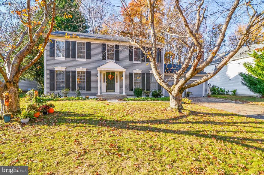 This lovely home is situated on a picture perfect cul de sac in the Tall Oaks Crossing Community in Bowie. The colonial style home sits on a large lot, with cherry blossom trees in the front and a huge back yard that backs up to a wooded area, where the new owners can take a walking path to a well-kept community playground. Bring your personal style and gain some instant sweat-equity in this virtually move-in ready home with 2 full bathrooms and 4 bedrooms upstairs, including a spacious master suite with a walk-in closet. On the main floor you will find a formal living room, dining room, eat-in kitchen, and family room with sliding glass doors that open to a large 2 level deck and huge park-like back yard nestled amongst the trees. There is a partially finished basement, great for a playroom, an extra bedroom with a walk-in closet, a third full bathroom, and loads of unfinished space ideal for storage, a workshop, or future renovation. There is a walk-up access to the backyard; 2 car large attached garage and ample street parking. A great commuter location with easy access to Routes 495, 50, and 301. Spend your holidays here!