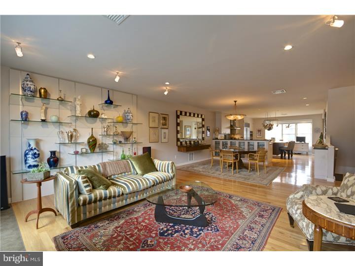 Spectacular 7 yr. old Contemporary Townhome located in the Artisan 1 Gated Community. Gourmet Chef's Kitchen with a Wolf range,Sub Zero refrigerator,Asko dishwasher,wall oven and microwave, granite & marble countertops,glass backsplash, large island with storage plus a large walk-in pantry closet.The Dining Room has a custom built-in cabinetry. The Great Room has a gas fireplace plus 2 doors leading to a large deck for outdoor entertaining. The 3rd level has a spacious Master Bedroom Suite with a walk-in closet and luxurious Master Bath complete with a steam shower, 2 sinks,radiant heat floors,recessed medicine cabinets plus custom cabinetry for great additional storage. The large 2nd bedroom(originally 2 bedrooms)has a large walk-in closet. The tile/stone Hall Bath has custom vanity and a tub/shower. The ground floor has a Bedroom/office,Full Bath, walk-in Laundry Room with storage plus 2 closets. The lower level Family Room has a custom built-in wine storage area(650 bottles), TV plus utility closet with storage. The roof deck has a hot tub, green roof plus panoramic views of Center City. Upgrades include surround sound,hardwood floors,recessed lighting throughout,2 zone HVAC, security system w/ cameras,customized closets,custom cabinetry, heat exchange ventilation system in the basement plus much more. This home can not be duplicated at this price. 3 yrs left on Tax Abatement.