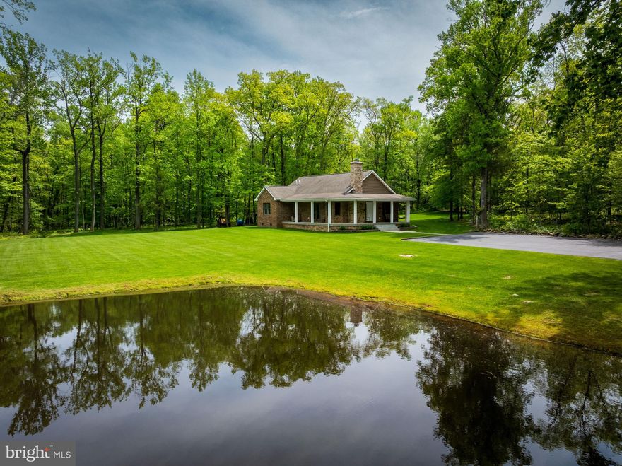 Welcome to your slice of paradise in Frederick County. This 27.34-acre wooded estate offers unmatched privacy, seclusion, and the best of country living--all behind a secure gated entrance shared only with a neighboring property via a deeded right-of-way. The owners completely rebuilt the home as well as entirely redesigned the landscaping to provide a great yard space, which opens the mountain surroundings, providing more sunlight. The pond was also dredged, improving the health of the pond and fishing. The custom-built home, completed in 2014, sits on the site of a previous residence and was designed with thoughtful craftsmanship and functionality in mind. With 3 spacious bedrooms, 2 full bathrooms, and a cozy wood-burning fireplace, the home perfectly blends comfort and rustic charm. Every detail speaks to quality and intention. Nature lovers and outdoor enthusiasts will be captivated by the landscape: a stocked pond with bass and catfish, and mature woods full of wildlife. Multiple hunting stands, including two premium 360 Hunting Blinds and 3 ladder stands, offer excellent recreational opportunities. Additional features include a home security system, custom cabinetry, granite countertops, hardwood floors, two outbuildings: a wood storage shed with a concrete floor and a Conex storage container, as well as a 9kW Generac for peace of mind. The wooded acreage is perfect for hiking, hunting, or simply enjoying the solitude of nature. This property also allows for the possibility of subdivision, which could provide a buyer with the opportunity to earn back some of his/her investment. Whether you're looking for a weekend retreat, recreational haven, investment opportunity, or a forever home in the woods, this property delivers unmatched tranquility with all the essentials for rural living--custom, functional, and absolutely one-of-a-kind.