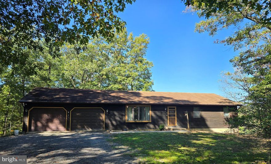 BEAUTIFUL VIEWS!!!  This 3 bedroom, 2 bath rancher is situated on 4.06 acres on the outskirts of Berkeley Springs.  The home features a large kitchen with wood floors and lots of cabinet space, connecting to a dining area with walk-out access to the covered deck.  Carpet throughout the living room and bedrooms provides a cozy feel.  Full bathroom, located in the hallway, conveys a tub/shower combo, while the primary bathroom provides a walk-in shower, and new laminate flooring which was just installed!  Primary bedroom also highlights the covered deck with another walk-out access.  Enjoy the beautiful views of the garden, mountains, and wildlife while you sip your morning coffee!  Lower level offers a blank slate with an unfinished walk-out basement, including laundry area, as well as “roughed-in” plumbing for a downstairs bathroom.  Outside structures include an oversized 2 car garage (with interior/home access) as well as a storage shed/hunting shack in the back yard.  If serenity is what you’re looking for, look no further!  This property is approximately 10 miles from downtown Berkeley Springs/Town of Bath with all its shops, spas, and restaurants, and just over 2 hours from Washington DC and Baltimore.  Find your mountain escape!  Schedule your showing today!