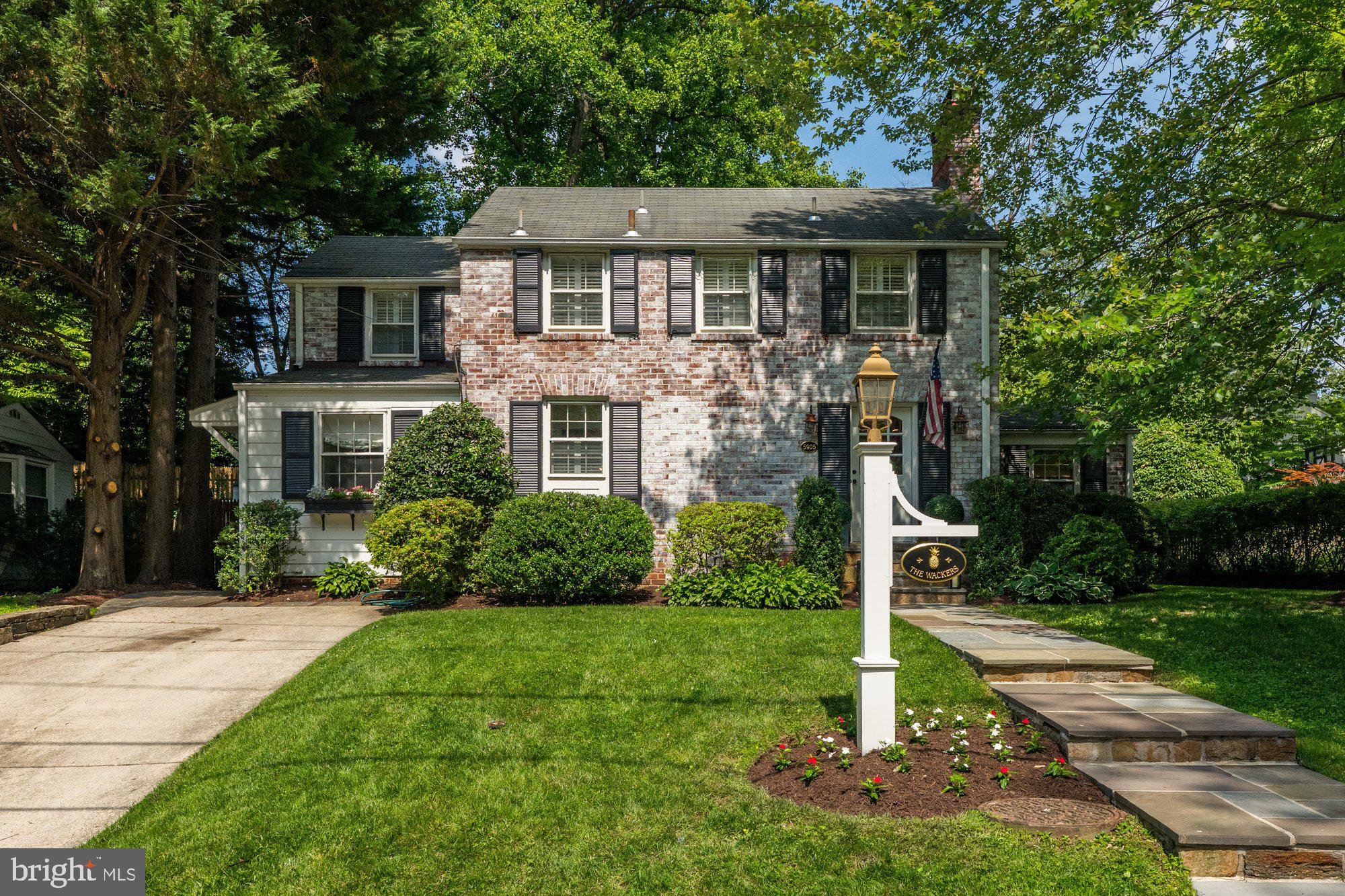 Colonial Charm Meets Modern Living in Bethesda! Welcome to 5905 Gloster Road—a beautifully expanded and thoughtfully updated home where timeless character meets sophisticated design. Every detail has been carefully curated for comfort, function, and style. Step into the inviting living room, complete with a gas fireplace. Adjacent is the private home office with cabinetry, offering a quiet and stylish space to work from home. The elegant formal dining room features glass French doors and custom wallcoverings. The sun-filled family room addition and informal dining banquette connect seamlessly with the large kitchen—outfitted with granite countertops, stainless steel appliances, a double oven, and a 4-burner gas cooktop—creating the perfect space for everyday living and entertaining. Upstairs, the primary suite is a serene retreat, featuring three closets and a marble-tiled en suite bath. Two additional bedrooms share a beautifully updated hall bath with tub. Plantation shutters and designer window treatments add polish throughout. The fully finished lower level offers a spacious recreation room, a Pinterest-worthy laundry area with ample storage and extra refrigerator, and a convenient half-bath. A custom sound system enhances the experience throughout the home and the outdoor entertaining areas. An EV charger is located at the top of the driveway. Step outside to an expansive hardscaped patio ideal for dining al fresco, surrounded by manicured landscaping and a fully fenced yard; this is the perfect setting for play and entertaining. Ideally located just around the corner from Wood Acres Park and Wood Acres Elementary School, and within the desirable Wood Acres, Pyle, and Whitman school district. Enjoy proximity to the Capital Crescent Trail, local shops, and an easy commute to DC via Massachusetts Avenue.