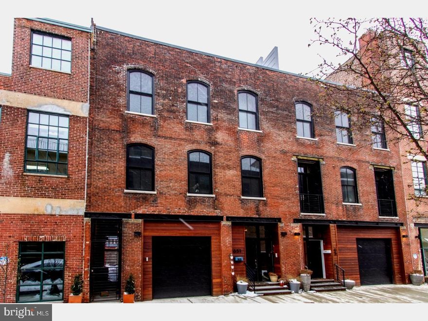 A true hidden gem on a rare private and gated street in the heart of picturesque and desirable Fairmount neighborhood. A historic warehouse restored and renovated with loving care by developers with an appreciation for the historical nature of the building and its outstanding original features.      This 3800 sq. ft. home lacks for nothing and will provide its new owners with that rare combination of luxury and living history.   You enter into a double height foyer and then move into a spacious den and full bath with exposed spiral architectural duct work, built in bookshelves, and french doors that lead into the rear yard and side alley. Wide plank wood floors throughout the house complement the abundant light streaming in from massive historically accurate arched windows.  The modern, open concept layout continues upstairs where the exposed brick barrel vaulted ceilings are worthy of an Architectural Digest spread and enhance the airy modern industrial feel. Custom wood cabinets and quartz countertops flank the chef's kitchen with high-end GE Monogram appliances including double oven's, and a pasta filling arm. The alcove office space, dining room and living room with remote controlled fireplace round out the second level.   The third floor has two spacious, light-filled bedrooms with custom closets, automatic window treatments, and a full bath with custom wood vanity and quartz countertop. Toes will never be cold because all bathrooms in this house have radiant heated floors. The master bedroom is a study in tranquility, with spacious custom walk-in closets and you won't want to ever leave the huge master bath with soaking tub, double custom vanity, and massive shower with steam system and Toto washlet toilet. The cherry on top of this magnificent house is the wet bar leading to the roof deck with 360 degree views of the city for elegant entertaining under the Philly skyline.   No expense has been spared at this home and the features are endless: Lutron lighting system, tankless high capacity instant water heater, automated window treatments in all rooms, two zone heat/air with Nest thermostats. 9.5 years left on the 10-year tax abatement and there is the possibility to add two more bedrooms to the first floor as the neighboring house has done.  This house is very lightly lived in as it was completed just 8 months ago.