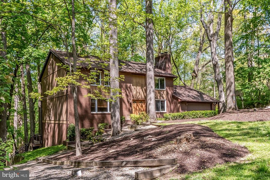 Find your way home on Gardenview, nestled deep in the woods of Stevenson Park in Pikesville. This Custom Home is perched on a corner lot with ample views of the forest and stream bed running through Greenspring Valley, and into Jones Falls. Speaking of Jones Falls, the JFX is conveniently just down the street making trips downtown for a night of music, or to work in the Baltimore / DC Metro Area. When arriving home, you will pull right into your own driveway, and 2 car garage with interior access. The garage opens conveniently into a Mud Room / Laundry Room with Back Deck Access as well. You can come right in from hiking and throw your muddy clothes in the wash right before cooking dinner. The Laundry Room is off of the Open Kitchen / Eat-In Breakfast Area and Family Room. This is the heart of the home where homework, holidays, and home cooked meals have been and will continue to be shared. Alternatively, a large Formal Dining Room with Built-ins that connects to a large Formal Living Room space. Guests will arrive through the Double Entry Doors and into the Foyer and be greeted with a Hall Closet and Half Bath in the Hallway that leads to the Kitchen and out to the Covered Deck Area. Up the stairs, to the right is the Primary Suite with a Den and Ensuite Bath. To the left there are 3 Bedrooms and One Full Bath, all ready for someone's final decorative touches! Last but not least, the Large finished basement boasts room for a home office, gym / Meditation Space/ Storage / Family Room / Art Studio / Playroom... The possibilities are endless! Looking forward to showing you around while you fall in love.