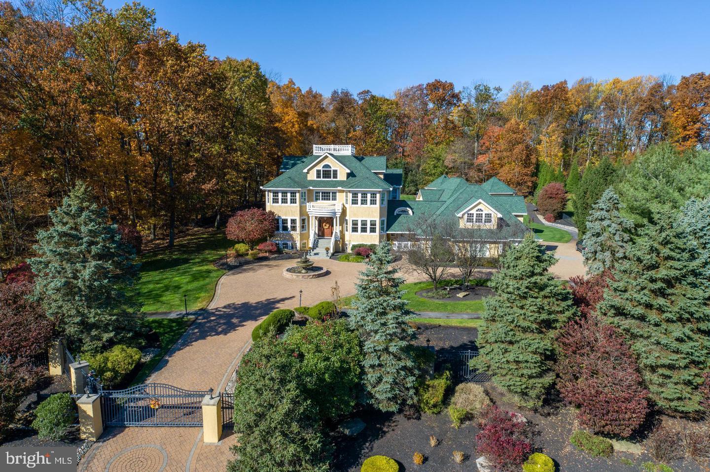 Price improvement! Simply Spectacular! Everything you'd ever want! The ultimate in Luxury and Entertainment living! Country Club like Indoor Pool, Wine Cafe, Luxurious Movie Theatre, Putting Green, Full Court Basketball Court, Gym, Sauna, Walking Path, 20X24 new Dressing Room, AND an apartment with its own private entrance - and more! Stately Manor home accessed by an electronic gate.. PLEASE SEE COMPLETE LIST OF FEATURES AND AMENITIES IN THE SELLER DISCLOSURE SECTION. A country club sized indoor pool with vaulted ceilings, raised hot tub and separate bath. The landscape architecture of this home is impeccable and includes an architectural fountain, tiered waterfall and pond, gazebo, large putting green, basketball/sports court with lighting, and a private walking trail surrounding the fenced property. Breathtaking center hall that features split staircases with wrap around balconies. Gorgeous hardwood flooring and moldings throughout. You can work from home from your French door enclosed office/study with a gas fireplace, floor to ceiling built in shelving. Expansive dining room with tray ceilings and double crown molding with uplighting. The kitchen/ breakfast area has granite countertops both Island seating and round table seating for 10 in the breakfast foom. Stainless steel appliances including refrigerator, 2 stoves, 2 Bosch dishwashers, gas cooking and recessed lighting. The adjacent family room has a large TV and gas fireplace. There is also a ½ bath. The second floor boasts 4 bedrooms including the Master suite that has been enhanced with a brand new 22x15 dressing room with free standing center Island with marble counters, 4 bench seating and full dressing and make-up areas, also with balcony access. The Master bedroom itself is large and has a gas fireplace. Master bath has a jacuzzi soaking tub, double sinks with granite counters and a separate glass enclosed shower. The third floor has 2 new bedrooms and an updated bathroom. Spectacular movie theater with 8 extra comfortable recliners and its own large kitchenette. Spiral staircase goes to the roofdeck for some of the best views of the city. The beat goes on in the home’s lower level. Large gaming space that now holds a pool and knock hockey table. Expansive gym/yoga room and then relax in the steam room with a shower. After your workout, have a glass of fine wine in the wine café with a temperature controlled wine room holding up to 500 bottles of wine. Ready for more? Have a live-in Au Pair or have friends or family stay in the separate attached apartment with a private entrance Add to all this 3 zoned HVAC, 3 car garage, updated mudroom with new shelving, new Culligan Soft Water System, new LG Signature Washer and Dryer Natural light from every room, and so much more. Seller is offering a one year home warranty. This home is an ABSOLUTE MUST SEE.
