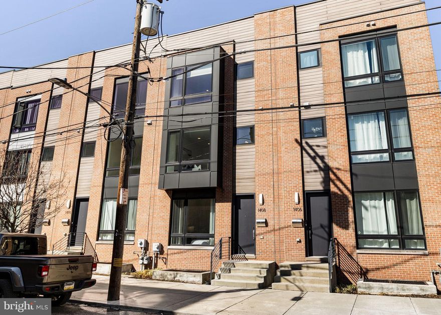 Step into luxury at 1408 S. Howard Street, a stunning 20-foot-wide townhome nestled in Pennsport's sought-after Reed Estates.  See seller incentives below.  Built in 2019, this 3,000+ sq ft gem offers 3-4 bedrooms, 3.5 baths, a finished lower level (perfect as a 4th bedroom), and the holy grail of city living—a two-car garage. And let’s talk outdoor spaces: a private kitchen balcony for your morning coffee and a rooftop deck with jaw-dropping 360-degree skyline views.

The first floor is all about versatility, featuring a spacious bedroom suite with a full bath—ideal for guests or a home office—two generous closets, and direct access to the two-car garage and finished lower level. On the second floor, you’ll find a modern haven with a chef’s kitchen that wows: quartz countertops, a huge island, custom cabinetry, and a brand-new refrigerator. The open-concept living and dining area, drenched in natural light, flows seamlessly to the balcony, making it perfect for entertaining.

Upstairs, the primary suite is a retreat unto itself, complete with a spa-inspired bath, designer closet, and custom built-ins. An additional en-suite bedroom and a laundry room outfitted with a brand-new, never-used washer and dryer round out the top floor.

This home is brimming with details that elevate the experience—from wide-plank hardwood floors and soaring ceilings to recessed lighting and 4 years remaining on the tax abatement. Plus, Reed Estates offers exclusive perks like a private dog park and a peaceful cul-de-sac setting. With local dining, parks, and I-95 just steps away, this home is the ultimate blend of space, style, and convenience. Don’t let this one slip away!

Seller will provide a $750 credit toward the buyer’s purchase of a home warranty at closing. Seller is also offering up to $12,000 in buyer assistance (up to $1,000 per month for 12 months) which may be applied toward buyer closing costs, interest rate buy-down, or other lender-approved mortgage assistance. All incentives subject to lender approval.