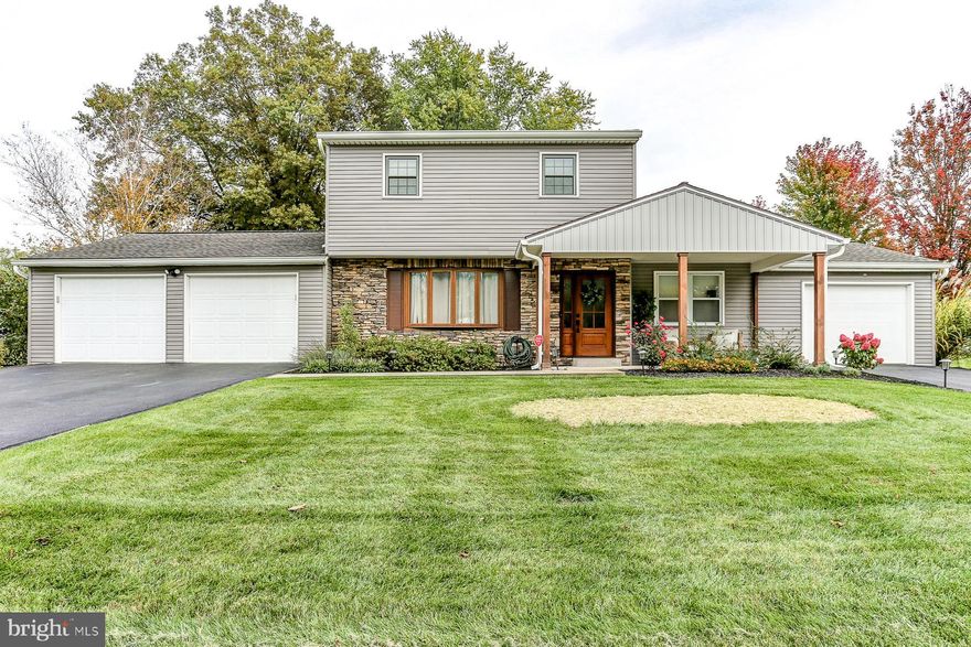 Welcome Home to this charming Two Story nestled in the desirable Bunker Hills Community in Hampden Township (think...low property taxes)! Totaling over 2,000 sq ft of finished living space, this home has so much for today's buyers that will set it apart from everything else out there on the market. As you pull your car up to this lovely home, the first things that will catch your eye will either be the plentiful amount of professional landscaping, just waking up from it's winter's slumber, that graces the front and rear yards OR the new vinyl siding OR the new covered front porch and stacked stone facade OR the 3 (THREE!) car garages. Once you catch your breath from that excitement and make your way towards the new front door and sidelights, you will enter into the inviting foyer with the custom, extra deep closet storage and you'll be greeted by the living room with custom built-ins. The living room leads you to the spacious dining room that offers an inviting space with a shiplap design, new lighting and more! The kitchen is truly something special with a unique layout that home cooks and gourmet chefs alike will appreciate. The chef's alcove with built in range and prep sink is not something that you see every day and will enjoy for years to come. Next is the brand new addition... The thought that was put into this space is 2nd to none with the full bathroom, laundry room, mud room and a pantry that looks like it belongs in a home double this price! Sitting on the other side of the kitchen is the warm and cozy family room w/ a brick faced fireplace and completes the first floor layout. Continue your tour through this enchanting home back to the foyer and take the stairs to the 2nd floor with the 3 well appointed bedrooms, all with beautiful wood flooring, plus the newly renovated 2nd floor full bathroom. The huge, finished lower level, with brand new carpet, does not disappoint with enough space to stretch out and entertain with friends and family! The workshop with storage galore completes the lower level. And yes, there's more... check out the yard of this home- this amazing home is situated on almost a 1/2 acre with 2 sheds and 2 patios, perfect for year round enjoyment. Updated HVAC with multiple zones! This home has so much to offer, make it yours before the spring market hits.