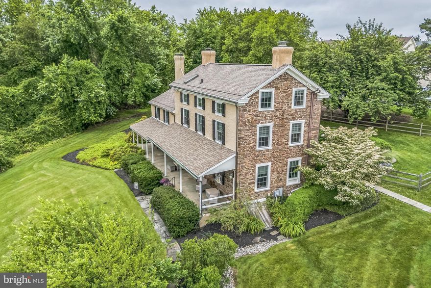 Do you want an updated antique home with deep roots in Bucks County history?  Do you also enjoy an upscale neighborhood with mature trees and walking paths?  This unique combo offers a private wooded setting on just over an acre located within the desirable community of New Britain Walk. BUT it's not part of the association and there's no association fee. Perched on a higher point in the community, the expansive front porch is the perfect conversation spot with serene views overlooking the community pond and wetlands, while the back patio delights as an outdoor gathering and entertainment space. The interior pays homage to its historic roots with an authentic, thoughtful and extensive upgrade -- aesthetically, structurally and mechanically (full list available). The traditional center hall invites you to both the kitchen and dining rooms, as well as to the upstairs.  The kitchen is light and bright in a tasteful farmhouse style with oversized island, while the dining room brings you back in time with large Mercer Tile fireplace and built-ins. Beyond is the main gathering room with extra large stone fireplace, built-in office/craft space, with an additional game room/office attached.  Beyond the main staircase is a mud room with access to the back patio, main-floor laundry and half bath. Upstairs enter into the primary suite through a large sitting room/office, then into the bedroom with exposed stone, rustic private bath and an unexpectedly grand walk-in closet with island and built-ins.  The second level also has the second bedroom and hall bath with tub/shower and barn-door closet.  Up to the third floor and you're greeted with two ample bedrooms and half bath. The detached garage has two main garage bays, with a third smaller one in the rear, as well as an upstairs storage area.  An upgraded antique home with lots of closet space, public water and sewer, private yet part of a community... you need to see it in person to truly appreciate.