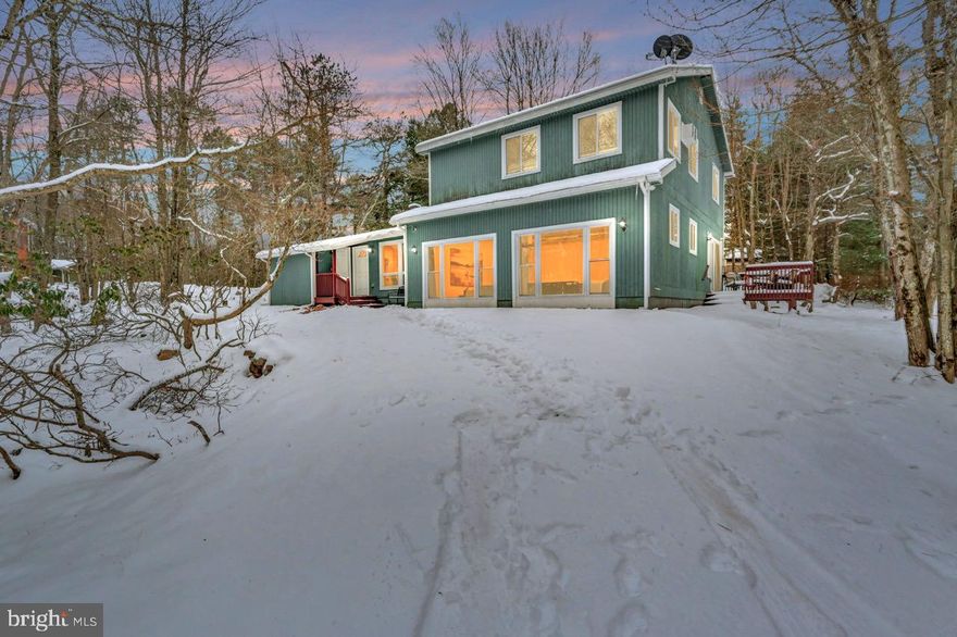 Beautiful Corner Lot in Lake Harmony! Enjoy the best of Pocono living with this spacious 5-bedroom, 3-bath fully furnished, Central HVAC home in stunning Split Rock—one of the few motorboat lakes in the region. Walk or golf cart to the beach lagoon, sandy beach, dining, and lake activities. With over 2,700 sq ft of living space, this home features a cozy wood-burning fireplace, projection movie theater room, and flat-screen TVs in every bedroom. The side deck offers peaceful wooded views, perfect for morning coffee or evening relaxation. Outdoor highlights also include a firepit area for entertaining. Close to skiing, golf, waterparks, restaurants, and major Pocono attractions. No HOA! Use as a vacation home, full-time residence, or high-demand rental opportunity. Public sewer.