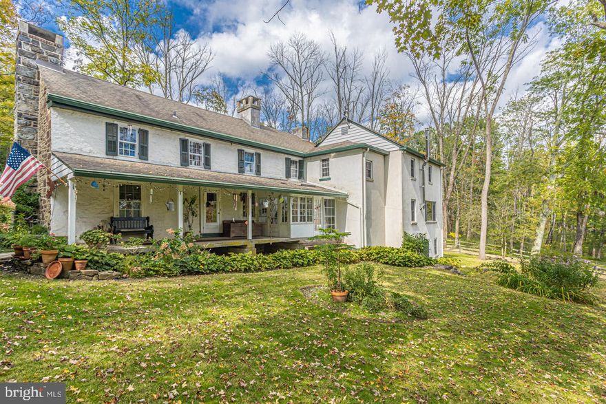 Calling all nature lovers!  Set on 80+ scenic acres, down a quarter mile drive through mature woodlands, and nicely removed from a quiet country road in historic Bucks County, Lottabucks is a hidden gem.  The owners have maintained this home with lots of attention to detail in keeping the farmhouse as original in appearance as possible. Featuring 5 fireplaces, 1 cast iron wood stove, 4 bedrooms and 2 ½ baths, this private property has lots of historic charm with modern amenities.  The interior features an updated eat-in kitchen with cherry cabinetry, wide planked cherry floors, stainless steel appliances, a double wall oven, granite countertops and a large center island with a prep sink and seating.  A cast iron wood burning stove set atop a slate platform against an exposed stone wall built  from the original farmhouse stone is sure to be the scene for many cozy meals.  Relax and enjoy the breathtaking views of the outdoors and abundance of natural light thru the large windows with deep sills.  The living room and dining room have exposed beam ceilings, original wood burning fireplaces and farmhouse doors leading to the outside.  Inviting details such as tavern green cabinetry, matching doors, detailed hardware and nature-inspired painted walls can be found throughout the home and bring out the rustic, antique nature.  The second floor has 4 sizeable bedrooms with plenty of closet space, one with a fireplace, and 2 sitting areas, one of which has its own fireplace.  As an added bonus one bedroom has a separate loft, directly above the room, making it a unique semi-hidden flex space.  There are 2 full baths, one with a jetted tub.  In addition to the main staircase, two sets of pie stairs provide convenient access to the first floor.  Wide plank pine floors grace the 2nd floor.  Lush vegetation set to bloom year-round can be found around the entire house, Robin Run Creek runs through the acreage and the original springhouse is still present.  Rounding out the property is the picture-perfect red and stone bank barn which provides multi-purpose storage.  The barn is primed for electric hook up.  Additional amenities include central air and a convenient portable generator hookup on the porch.  This property is perfect for those looking for a private sanctuary that combines rich original details with modern conveniences.  While still private, great shopping and dining is just a short drive away.  Don’t miss your chance to own this unique hidden gem!
