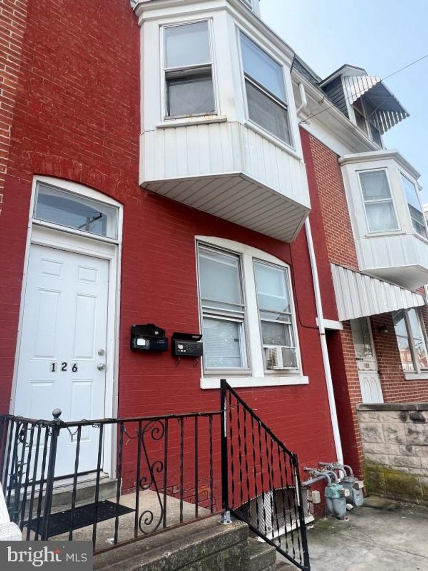 2nd floor 3 bedroom, 2 full bath (shower only) apartment with spacious living room, kitchen with stove and refrigerator and laundry room with washer/dryer hookups. No pets and no smoking indoors, 1-off street parking space in rear.