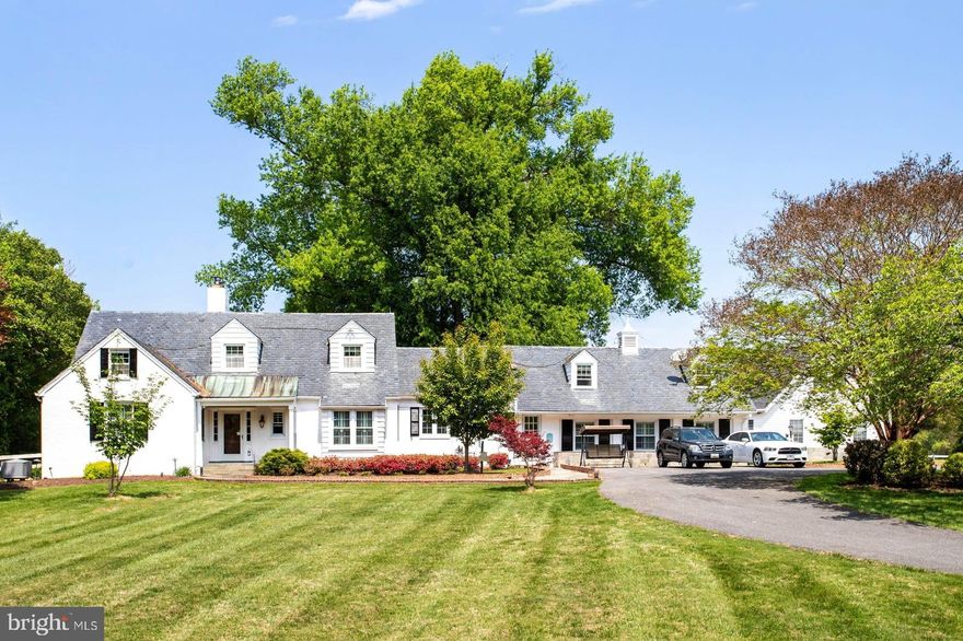 NEW ON MARKET! Amazing opportunity to own a piece of history! Meticulously renovated, updated & expanded, 1930's Colonial Farmhouse offers five bedrooms, four full & three half baths, tucked far off Travilah Road at the end of a quiet enclave on a sprawling 5.85 acre estate. Enjoy the same pastoral views from the living room picture windows where President FDR once marveled at Sugarloaf Mountain in the distance. This magnificent property features an in-ground pool, lighted tennis court, half basketball court, two story historic barn with eight stalls (four interior & four exterior), tack room, office with wood-burning fireplace. An additional detached, finished outbuilding has a variety of potential uses! The riding ring in front of the barn has been converted to a lighted soccer field and the hay loft has been remodeled to a finished hang out space perfect for parties! Inside you’ll find the main level primary suite with original hardwood flooring and amenities which offer modern conveniences including a large walk-in closet and updated spa like bath. There is ample room for family and friends to gather in the gourmet chef's kitchen, breakfast room with wood burning stove, as well as in the family room addition with a beautiful wall of custom built-ins. A charming, all-season porch with old world brick floors is the perfect retreat for relaxing or dining while overlooking the expansive backyard & pastures. Don't miss out on this one of a kind property. It is modern country living at its finest with close proximity to top rated schools, restaurants, shopping and major commuter routes.